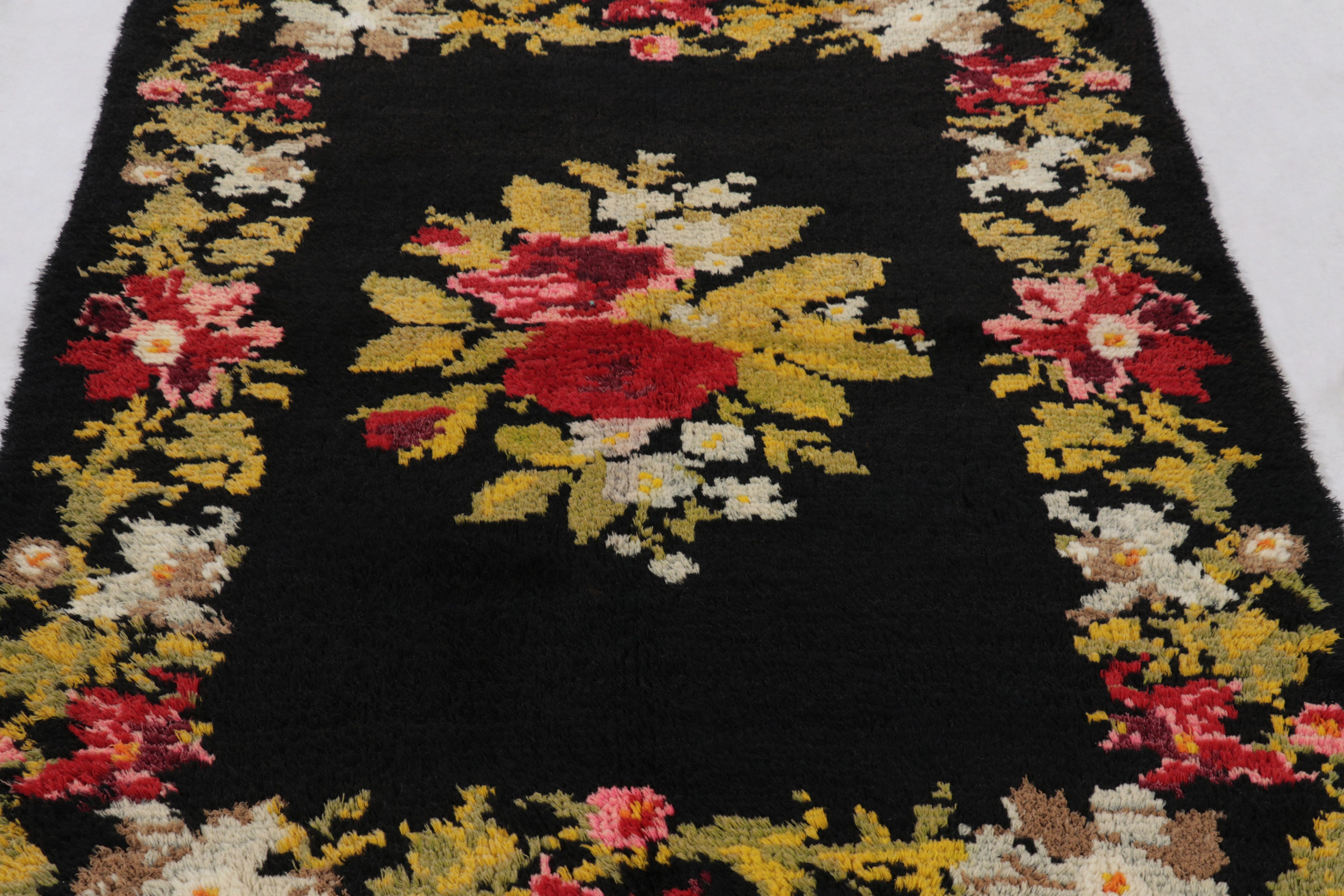 Made with hand-knotted high-pile wool in Turkey, this 4x6 vintage Tulu rug is a distinguished addition to Rug 
Kilim’s collection of traditional Turkish textiles. Its bold black ground and polychromatic floral design, inspired by Bessarabian