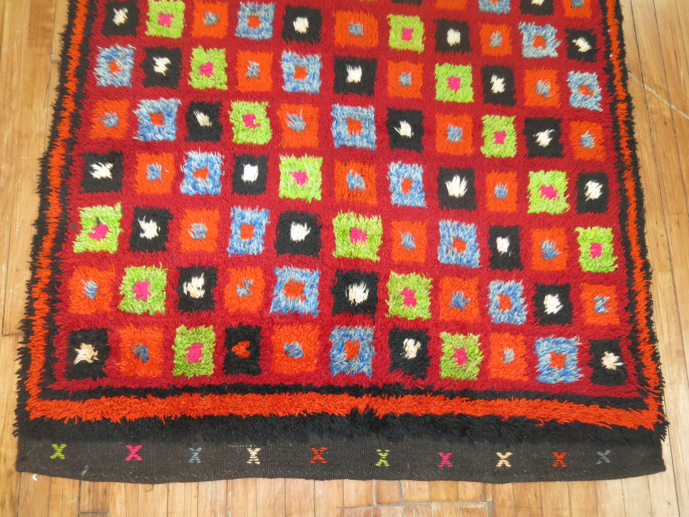 Bright colors highlight this mid-20th century intage Turkish Tulu rug.

4' x 4'11''