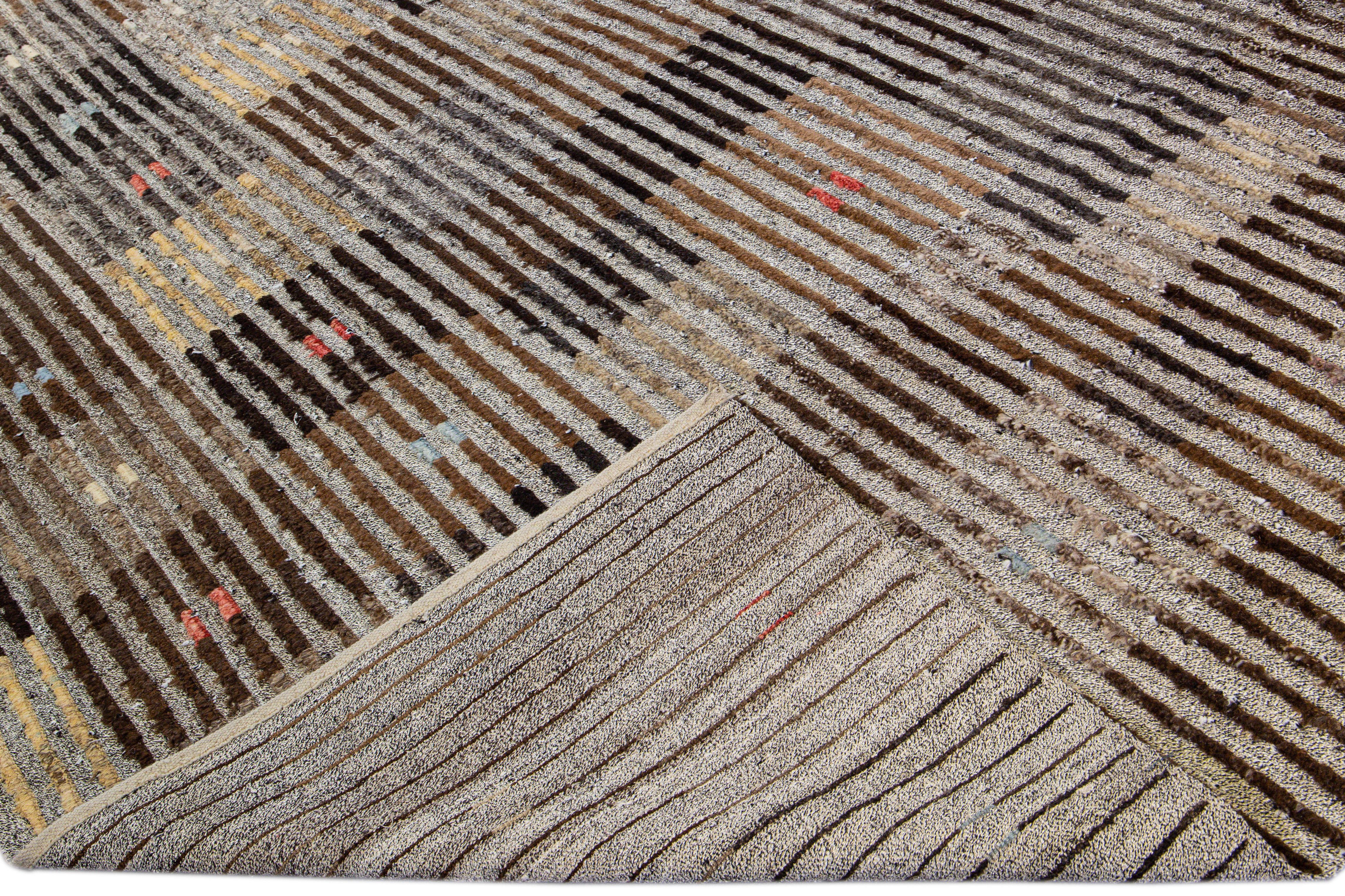 Beautiful Turkish Tulu handmade wool rug with a brown field. This Vintage rug has beige, orange, and blue accents in a gorgeous all-over geometric stripe design.

This rug measures: 10' x 14'2