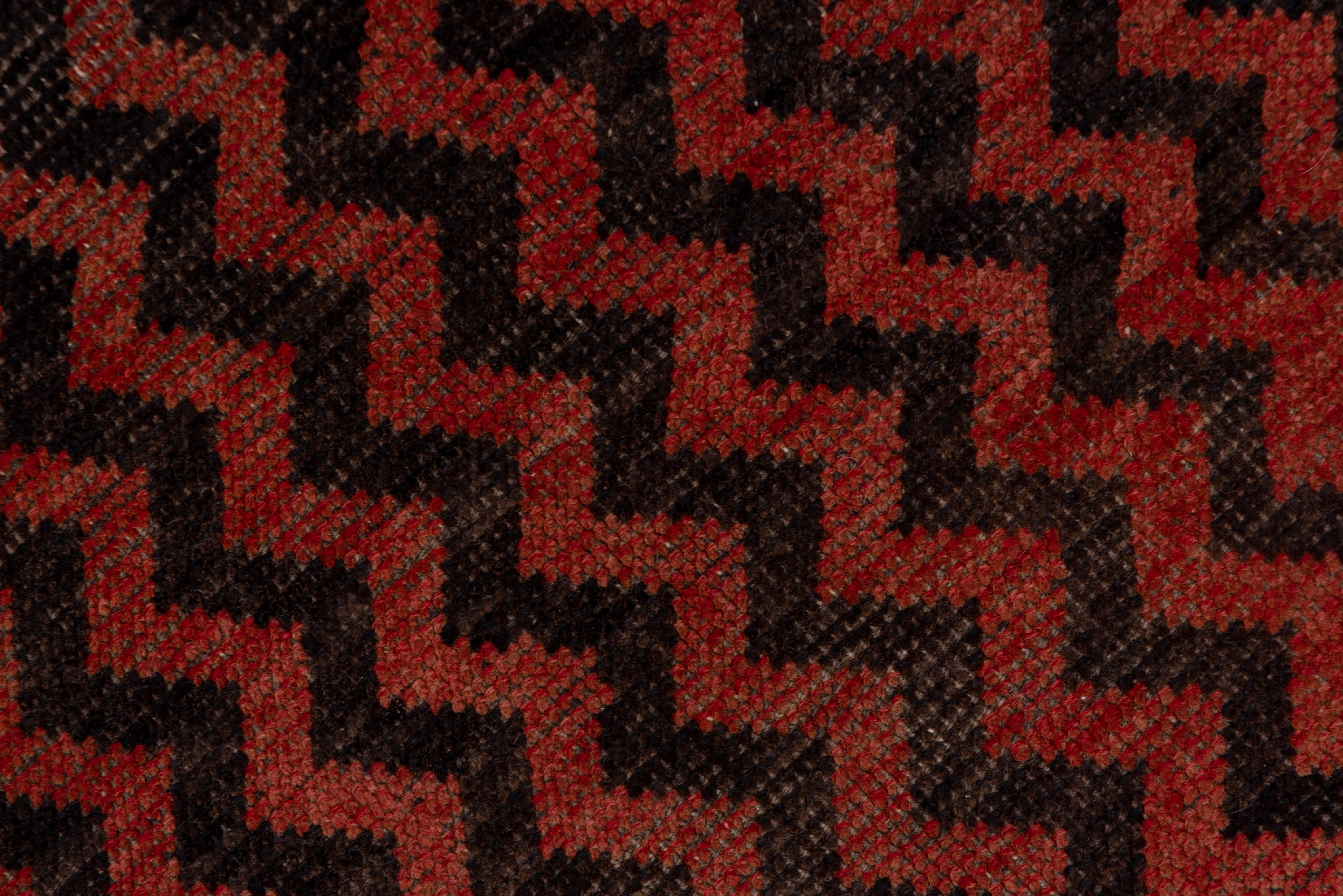 This central Turkish village carpet has no border and a striking vertical zig-zag pattern in abrashed soft red and charcoal.