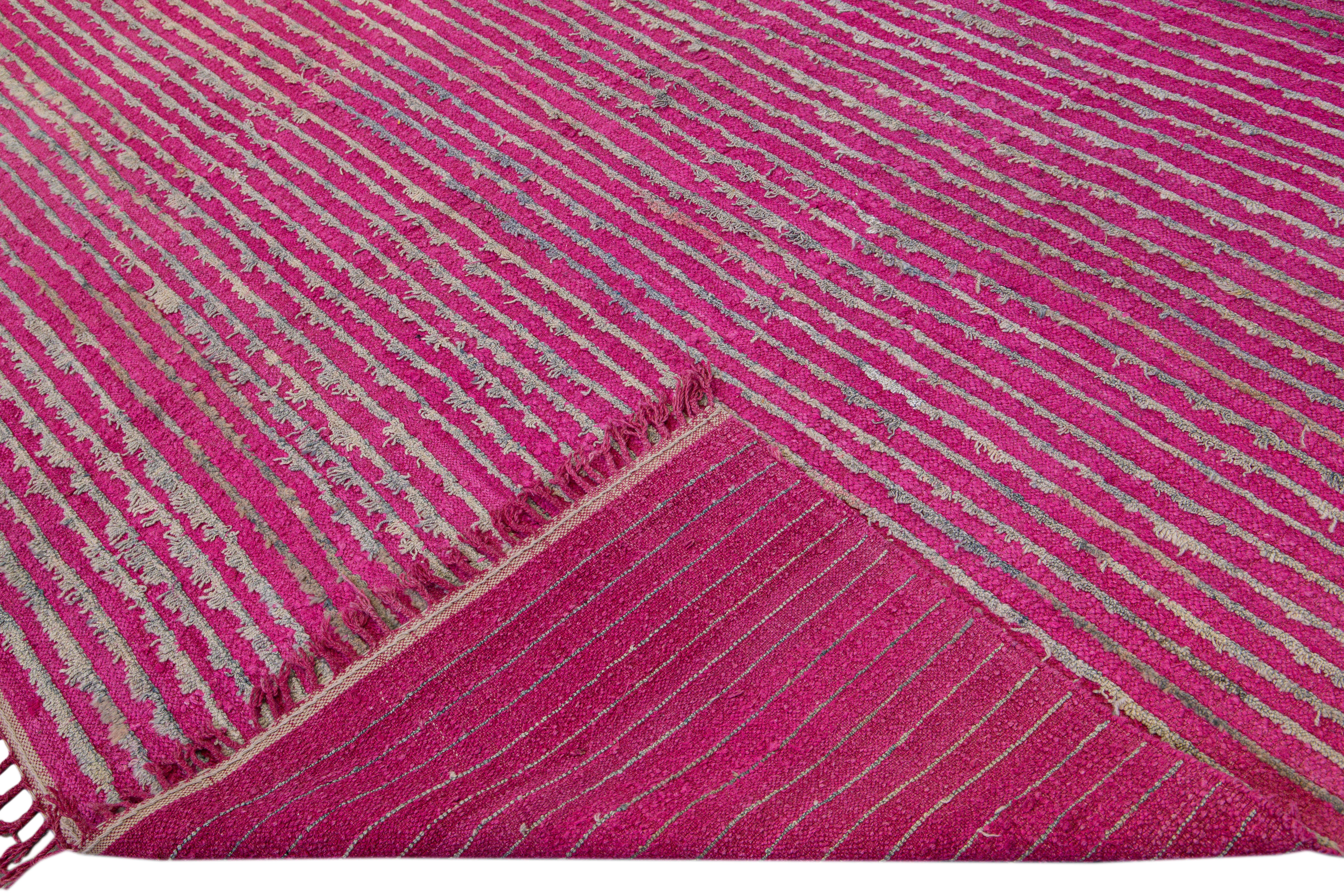 Beautiful vintage Tulu flatweave wool rug with a pink field. This Turkish rug has gray accents gorgeous all-over striped pattern design.

This rug measures: 8'9