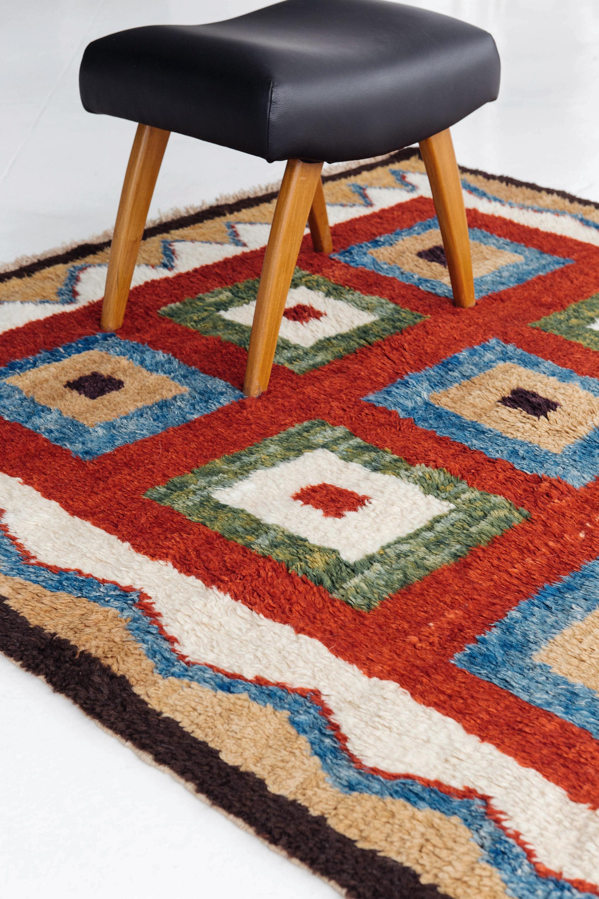 Bold, geometric patterned deep pile rug in ruby red, blue, green, ivory, brown, and warm tan. This vintage Turkish rug with Tulu pile is reminiscent of a Persian Gabbeh in palette and composition. 