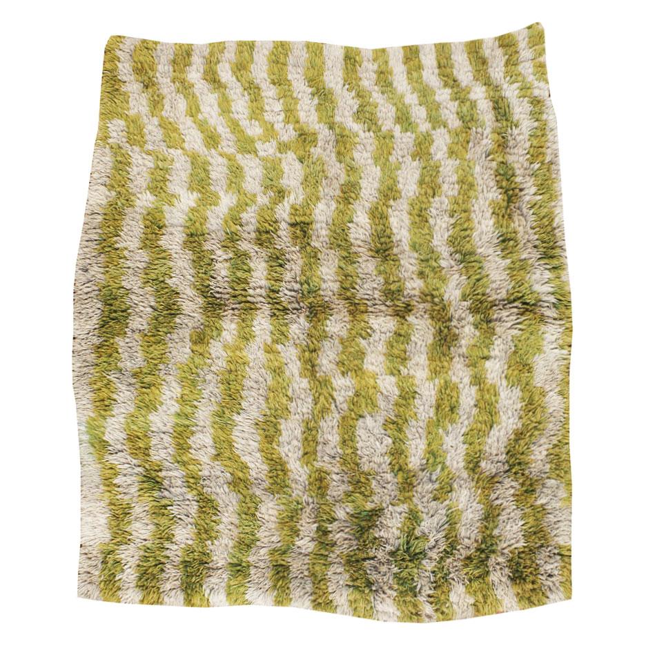 A vintage Turkish Tulu Folk rug handmade during the mid-20th century with vertical wavy stripes in chartreuse green and old ivory and with a plush and shaggy texture.

Refer to all updated images after the primary image for a true representation of