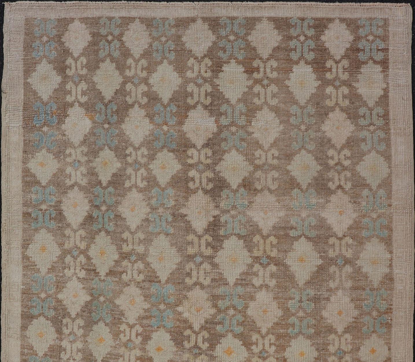 This modern-design vintage Turkish Tulu rug features an all-over Design with a black zig zag line connecting the flowers. Set on light brown background, the flower colors include soft gold, and light blue. 

Measures: 4'2 x 6'9 

All-Over Floral