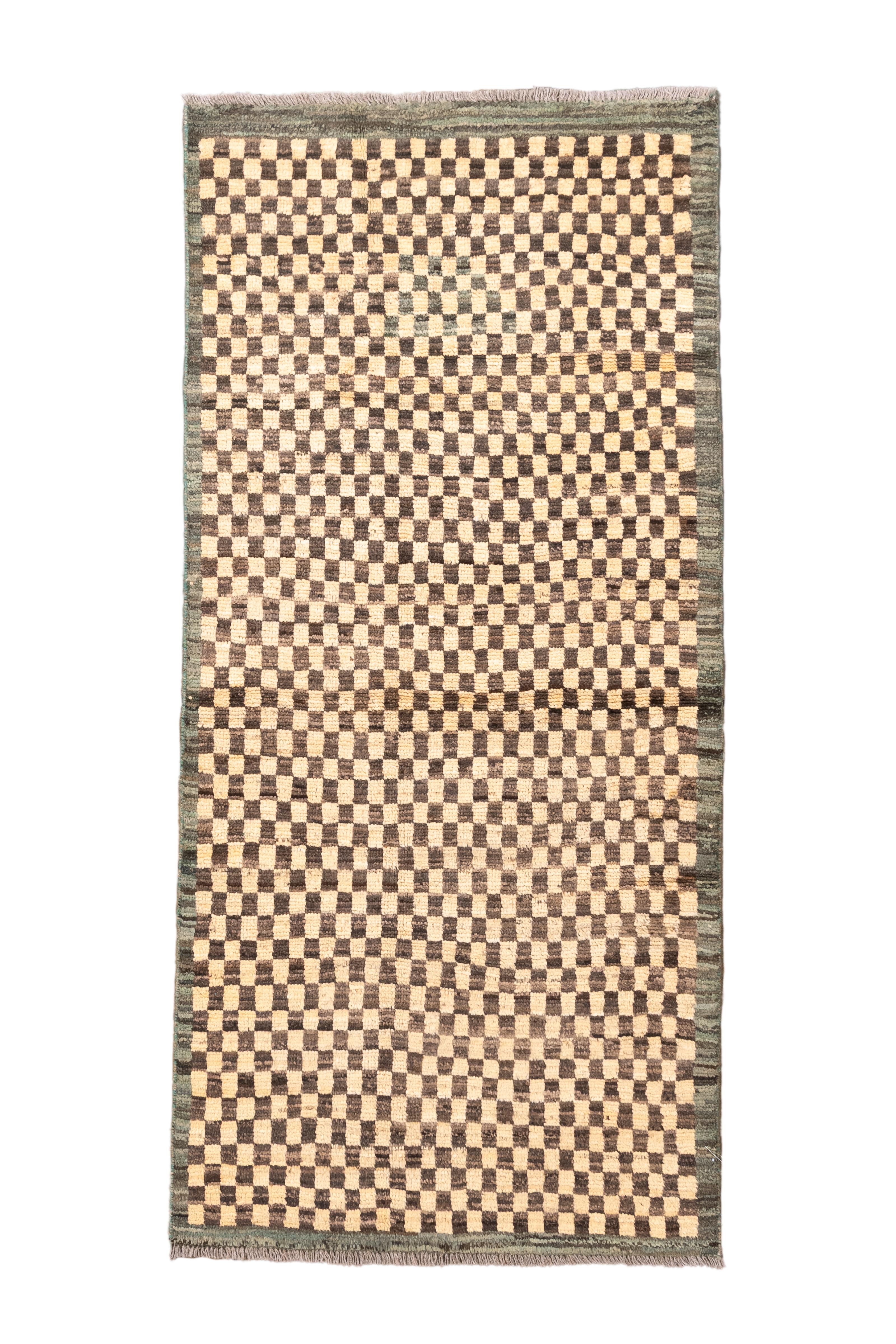  Minimal yet full of texture, this vintage Turkish Tulu rug features a striking checkerboard pattern in soft neutral tones. A rhythmic grid of alternating dark brown and beige wool squares forms a modernist composition that feels equally grounded in