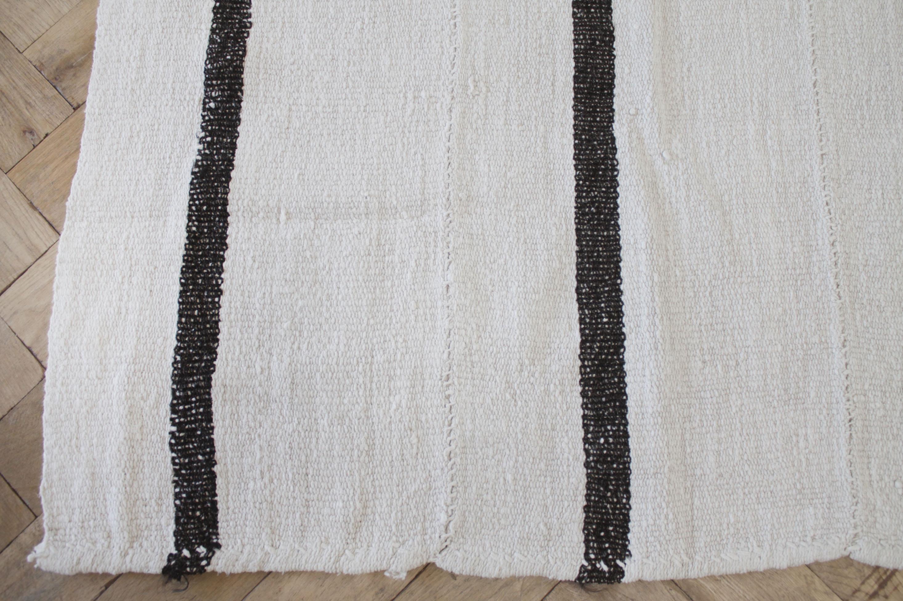 Vintage wool Turkish rug in creamy white with brown stripes.
Our new collection has arrived, these are great to use as a rug, or let us create a custom ottoman for your out of this piece. If you love this stripe and color combo, let us know your