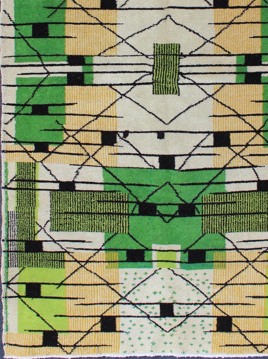Vintage Turkish Zeki Müren Mid-Century Modern Rug with Green colors, black, ivory and Tan. kwarug/Tu-Mtu-95170, 
Alive with invigorating shades of vivid green and contemporary patterns, this Turkish Zeki Mu¨ren rug with a Mid-Century Modern design