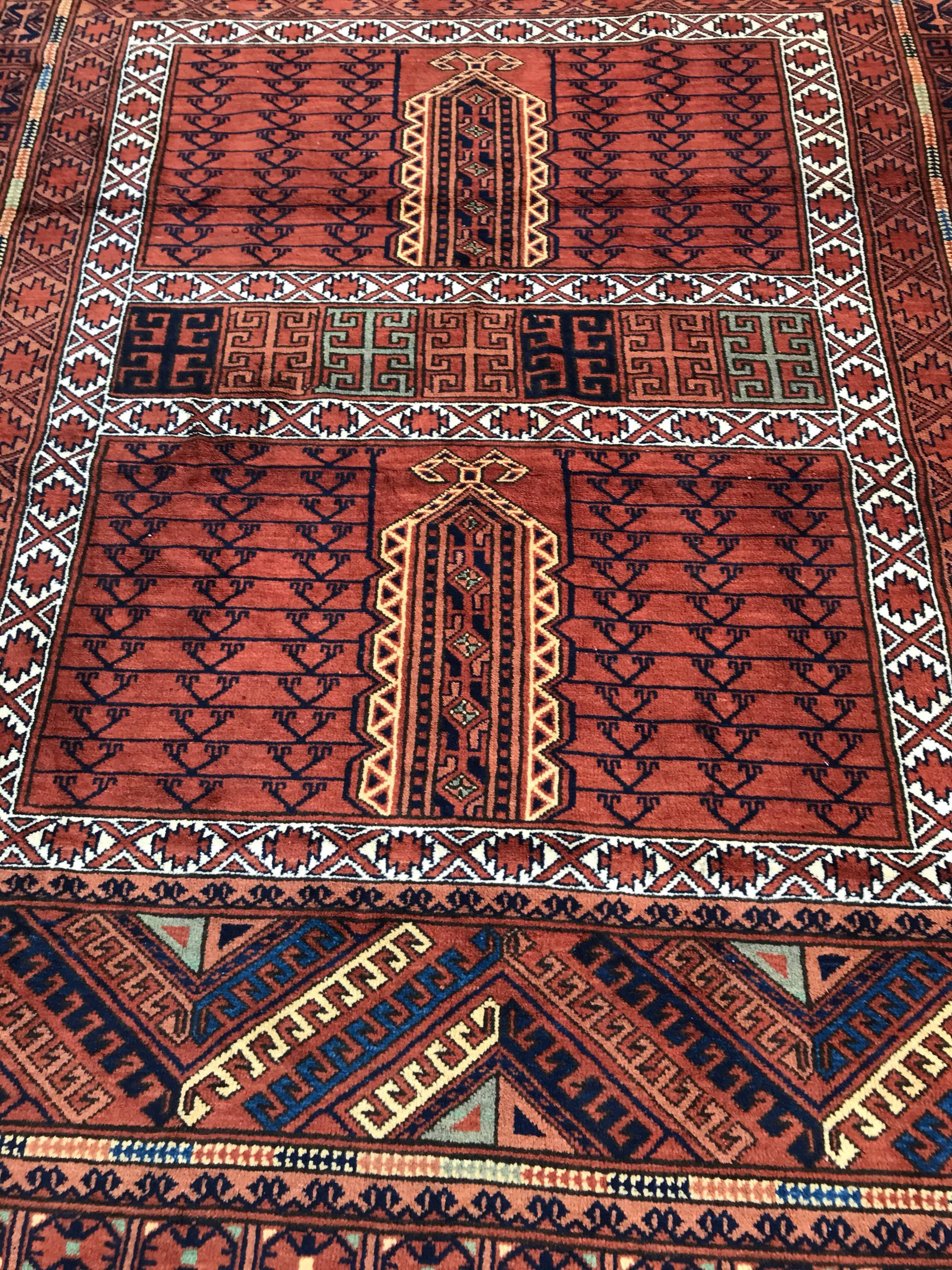 Beautiful late 20th century Afghan rug with a tribal Turkmen Hatchlou design and nice colors with brown, orange, yellow, blue and green, entirely hand knotted with wool velvet on cotton foundation.
  