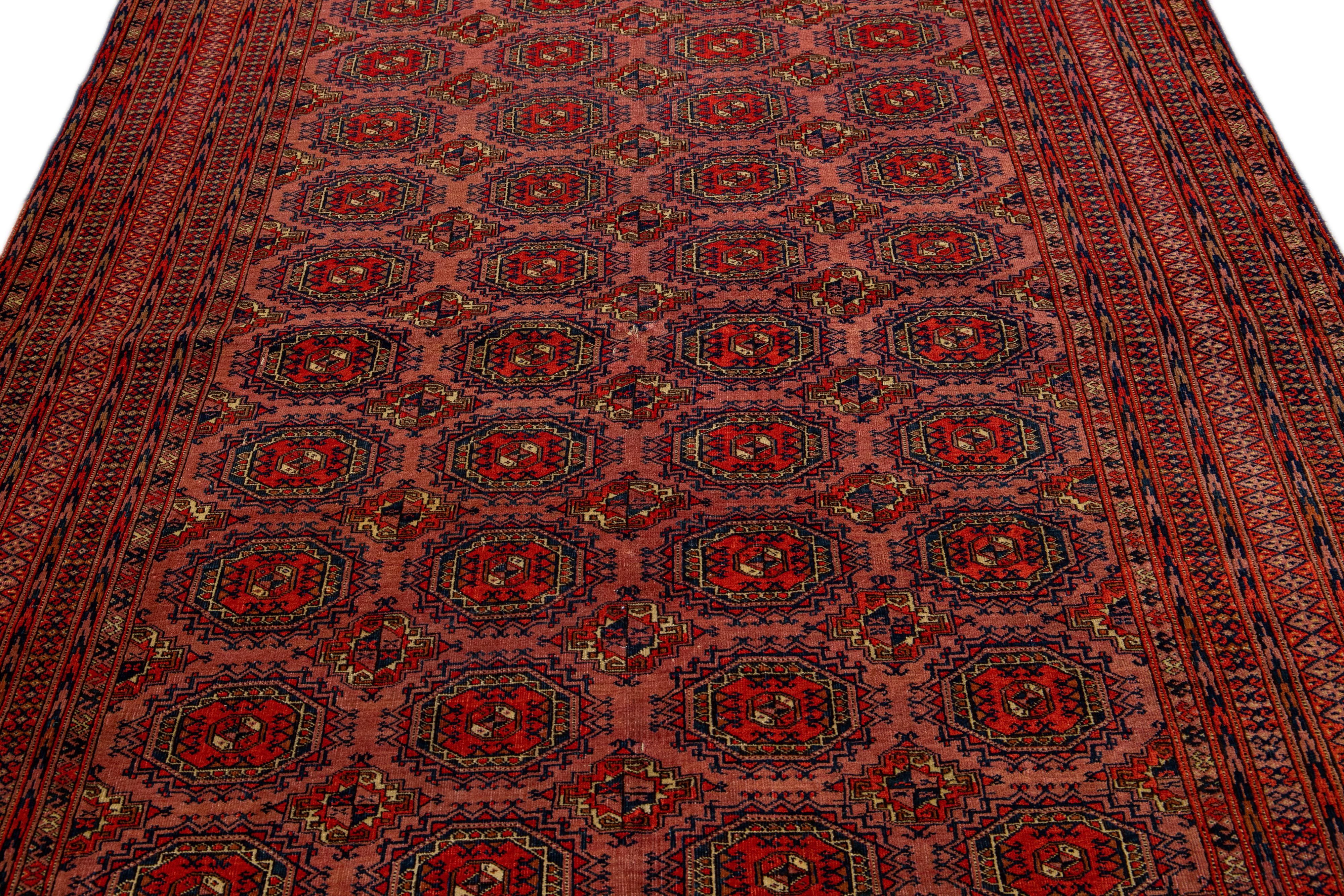 Islamic Vintage Turkmen Handmade Geometric Persian Wool Rug with Terracotta Color For Sale