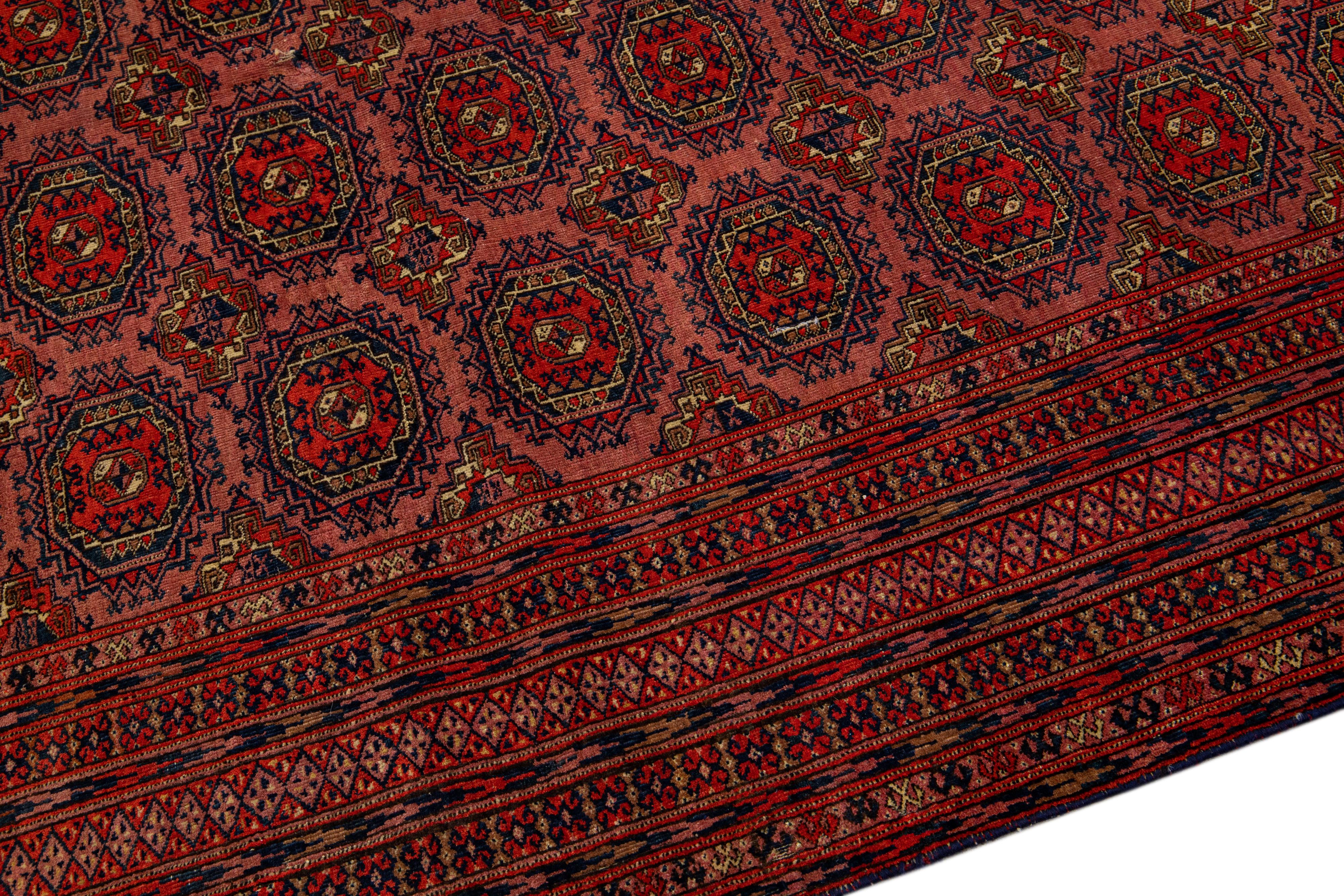 20th Century Vintage Turkmen Handmade Geometric Persian Wool Rug with Terracotta Color For Sale