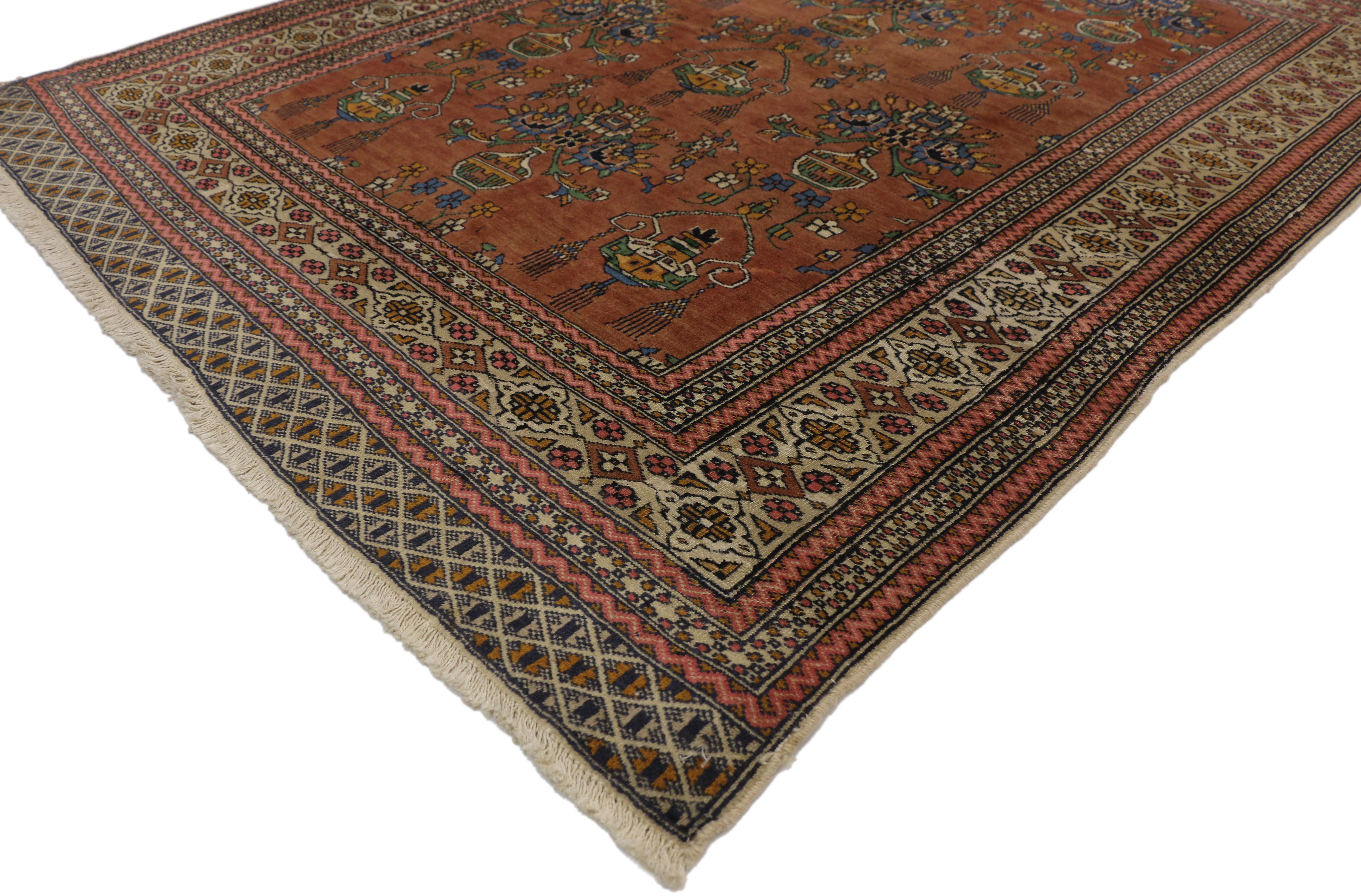 75959 vintage Turkmen Persian rug with Floral Vase design and Arts & Crafts style. This hand knotted wool vintage Turkmen Persian rug features a vase design overflowing with blooming lotus palmettes, stylized florals, and leafy tendrils on an