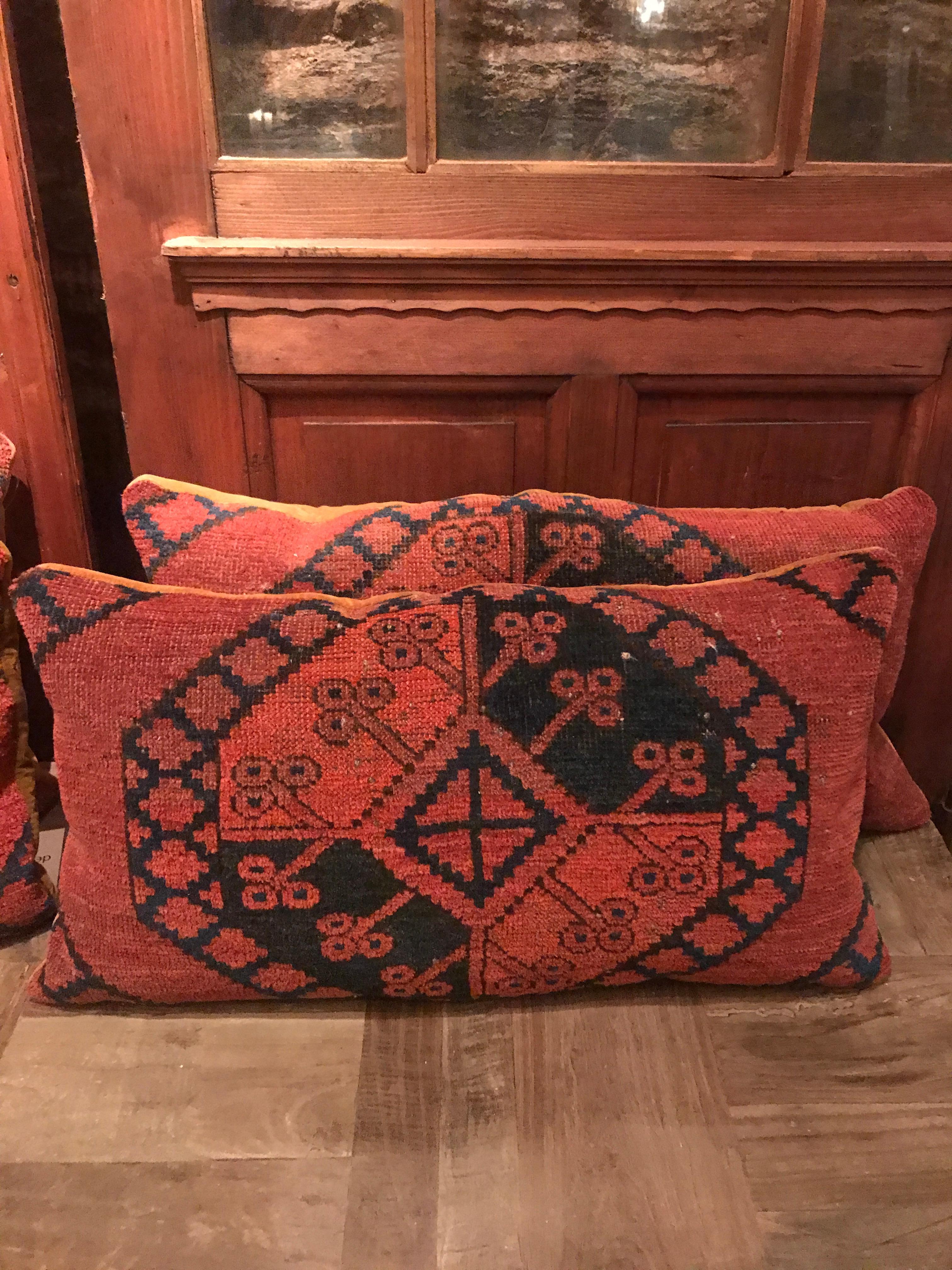A deconstructed vintage Turkmen rug transformed into a pillow. The signature pattern of a Turkmen rug proudly displayed centered with color still vibrant after all these years. Hand woven from the finest wool and dyed with vegetable dye. The backing