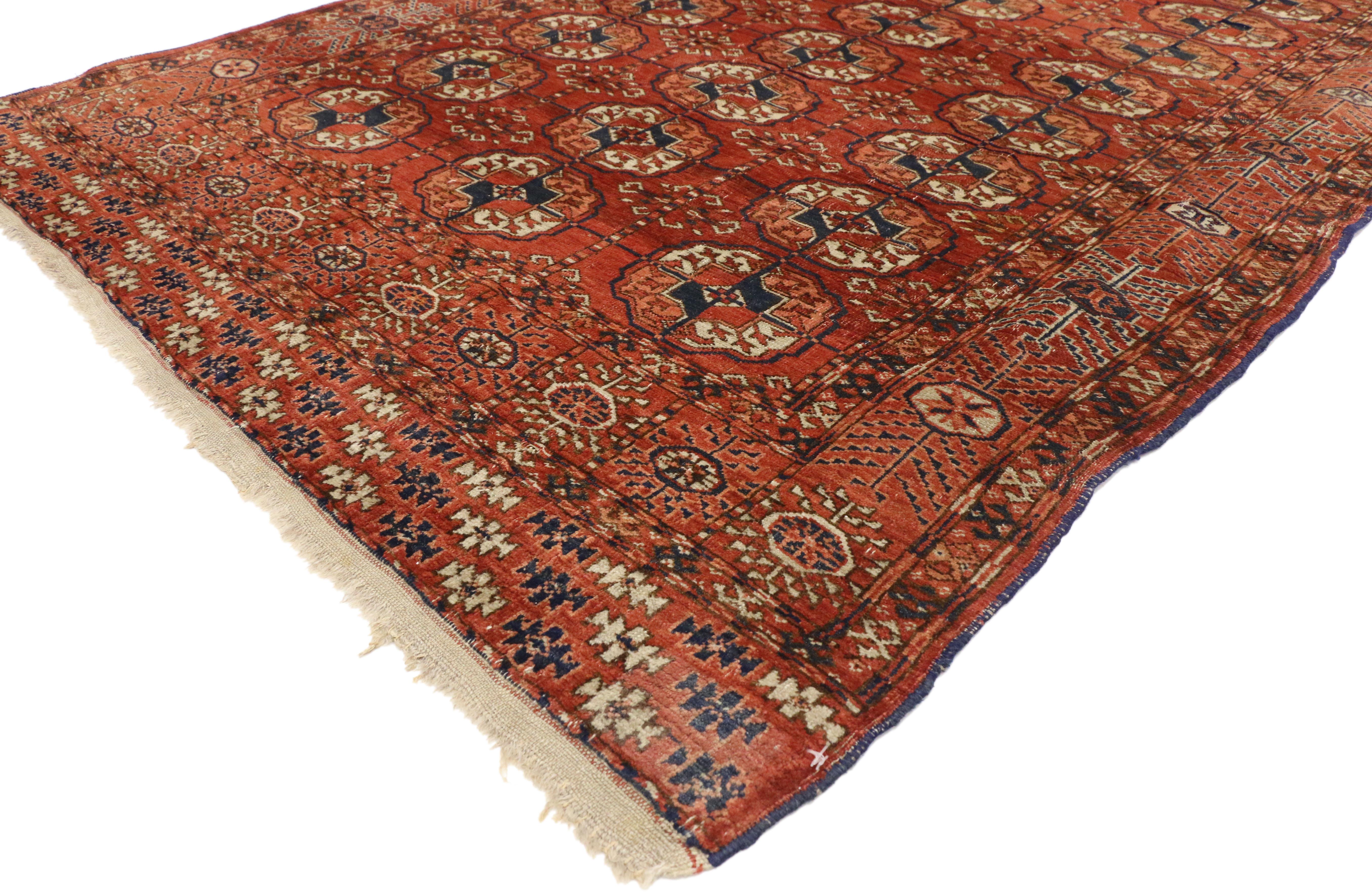 73274, Vintage Turkmen Rug with Modern Tribal Style, Tekke Accent Rug, Turkoman Rug. This hand knotted wool vintage Turkmen rug features three columns of Tekke güls with secondary stylized Chemche güls spread across an abrashed red field. The main