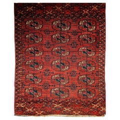 Tekke turcomano vintage con motivos geométricos en rojo, azul marino, marfil y azul