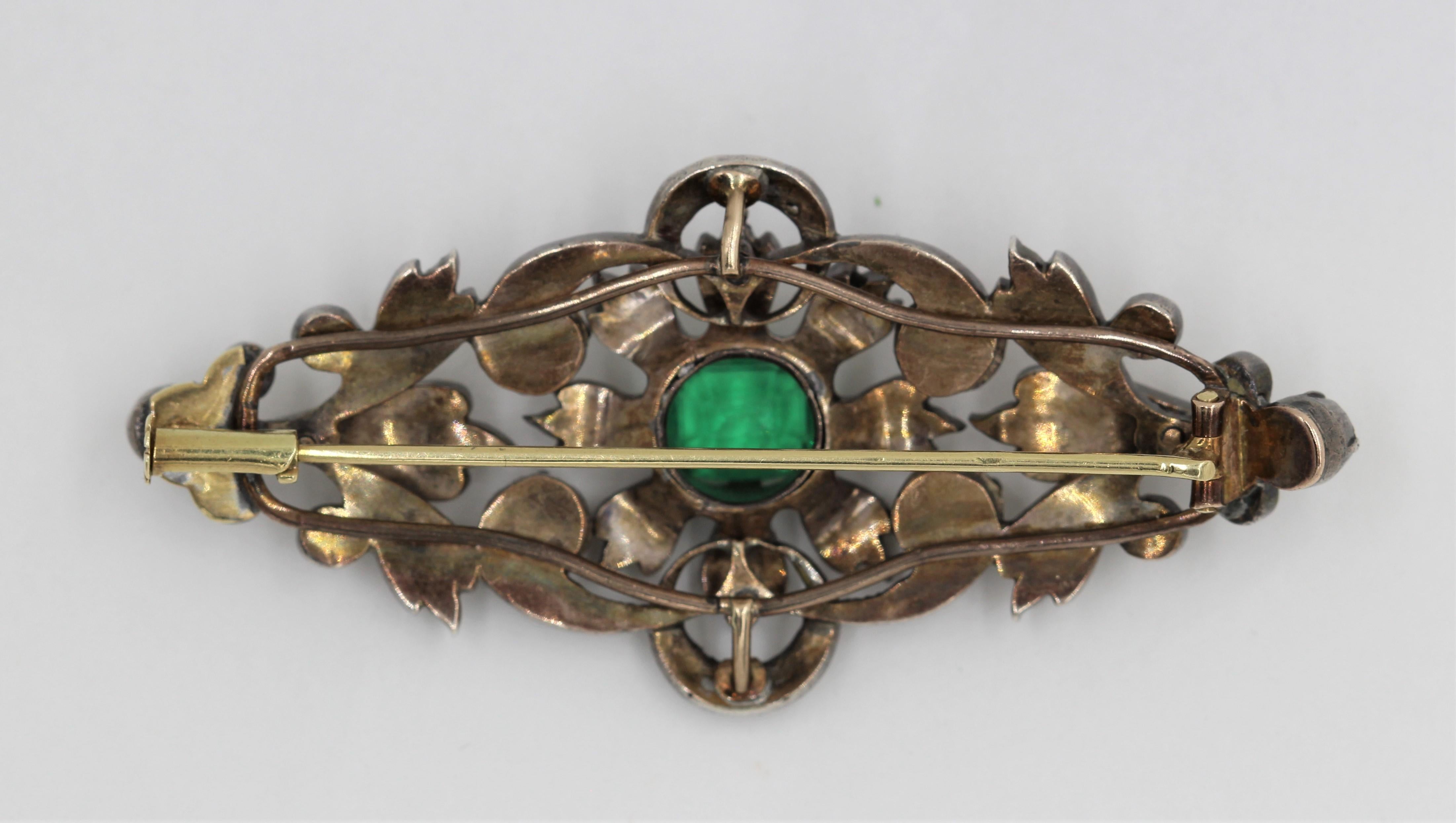 Fabulous Vintage Turn of the century 14k yellow gold and silver pin with 38 Rose Cut & Old Mine cut diamonds with a center Emerald Cut Emerald weighing approximately 2 Carats.
This old Antique pin is fashioned out of both Gold and Silver metals and