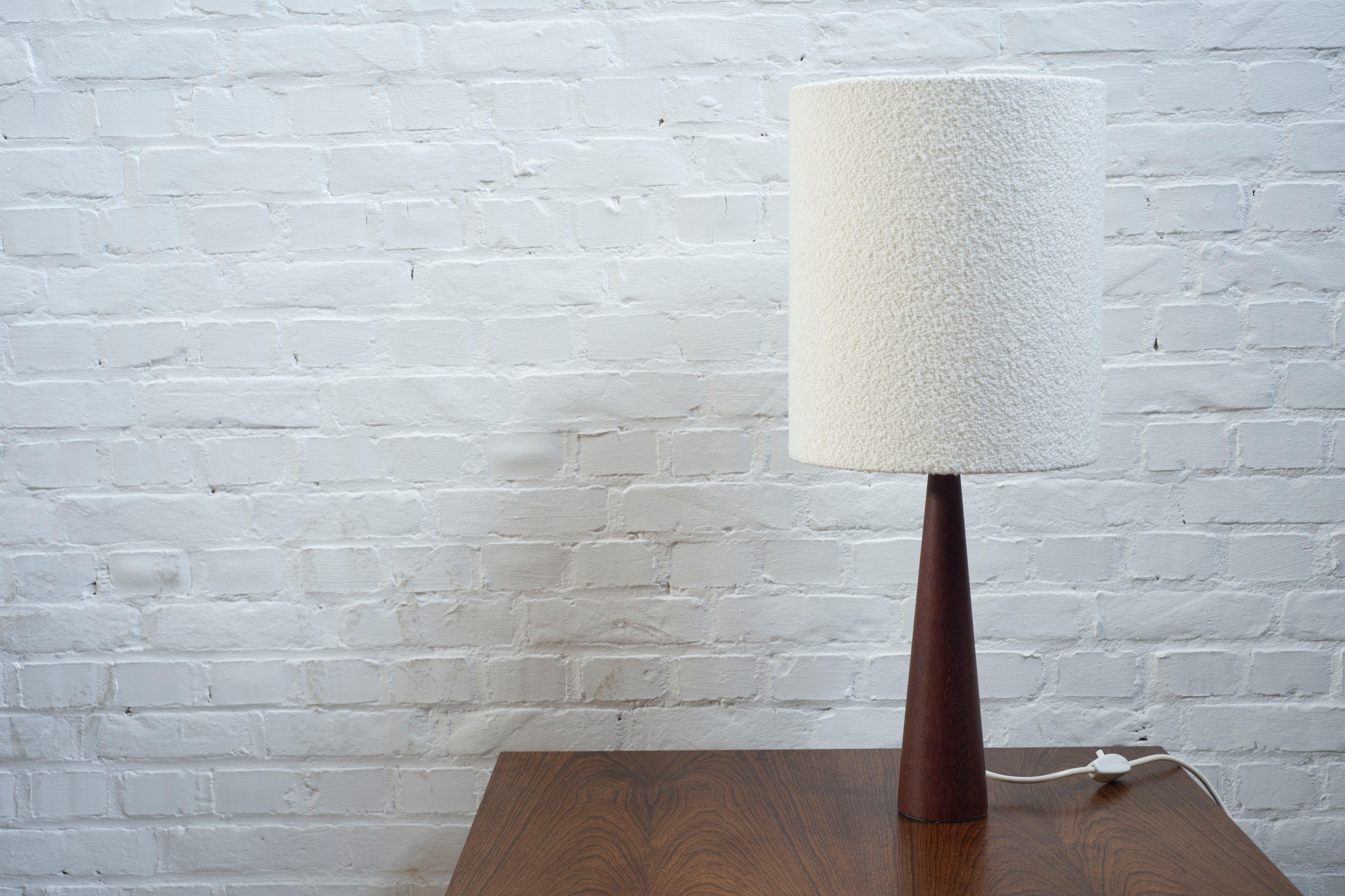 Vintage turned teak table lamp with a custom made boucle lampshade.

Danish design from 1960's or 1970's.

Lampshade diameter 25cm, Teak base diameter 8cm, Height 61cm

In very good vintage condition, fitted with a brand new custom boucle lamp shade.
