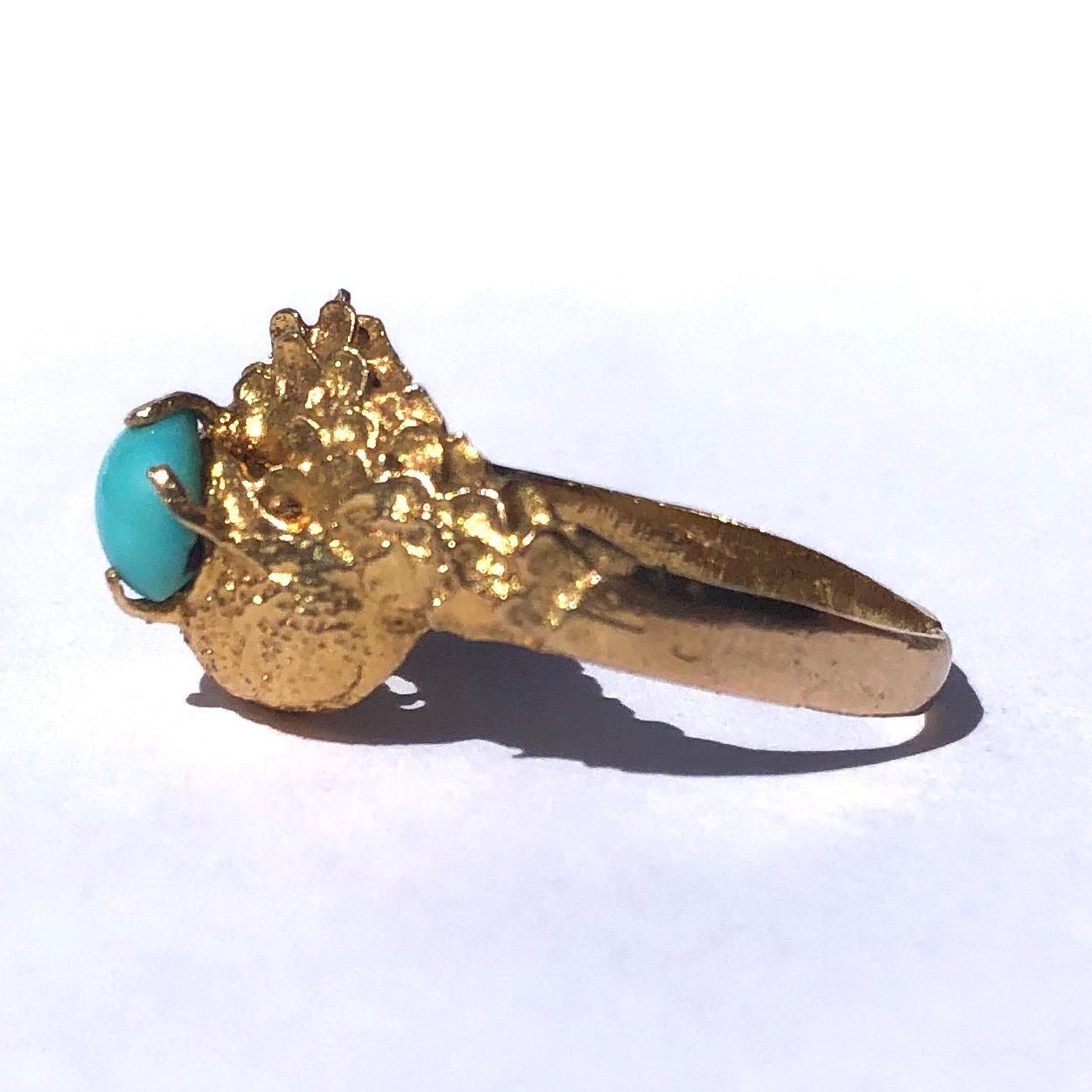 This turquoise ring has so much detail. The gold that's surrounds the stone is gorgeously textured, one texture looks like feathers and the other has a hammered effect with open work detail. 

Ring Size: N or 6 3/4
Widest Point: 12mm 
Height Off