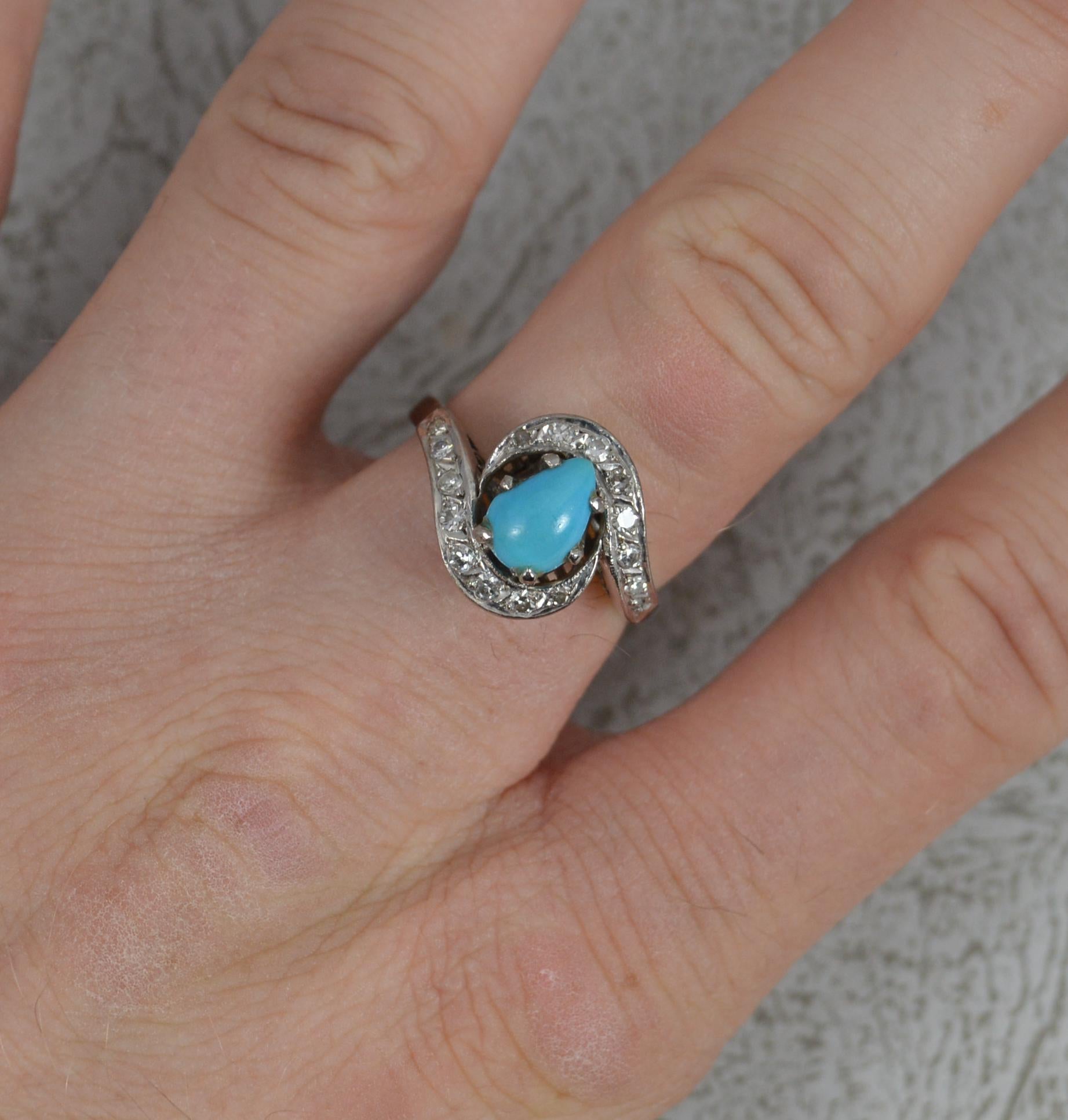 A stylish vintage cluster ring.
Solid 14 carat white gold example.
Set with a pear shaped turquoise to centre and small round cut diamonds surrounding on a twist.
17mm spread of stones. 13mm wide.

CONDITION ; Very good for age. Clean shank. Well
