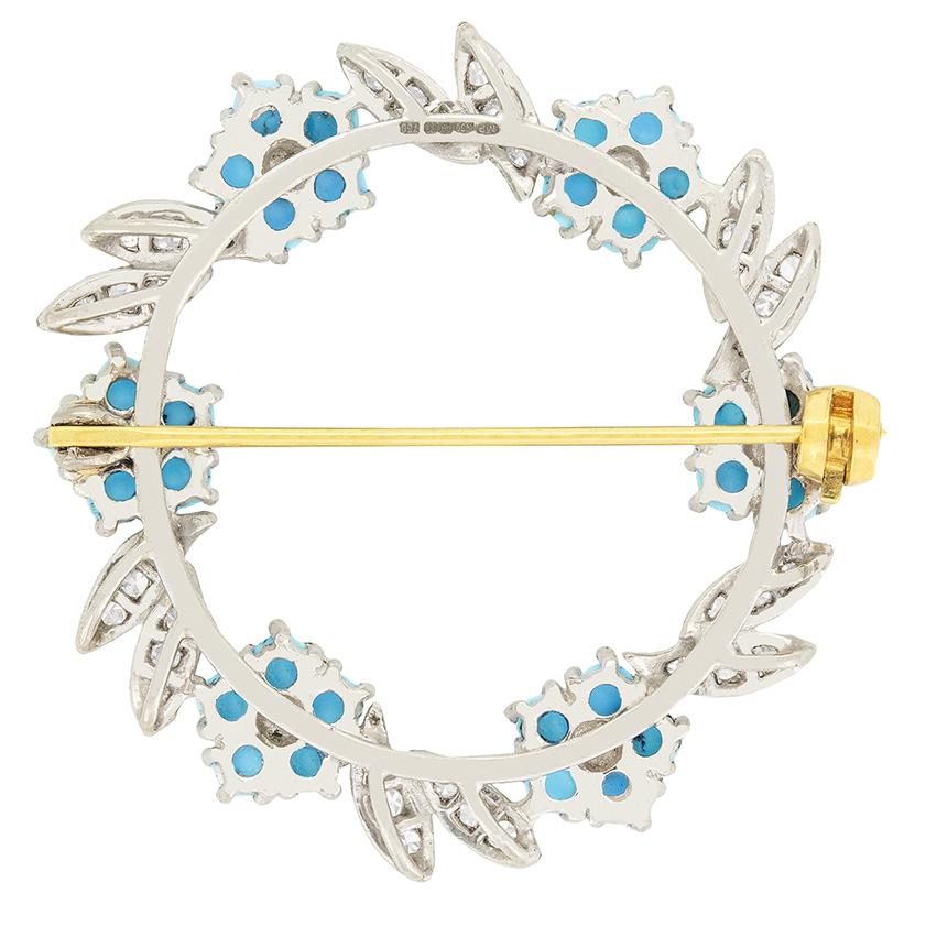 A delightful brooch dating back to the 70's is designed with a combination of luminous blue turquoises and dazzling diamonds. The turquoises have been formed in the shape of flowers, with a trio of eight cut diamonds cluster set into each leaf