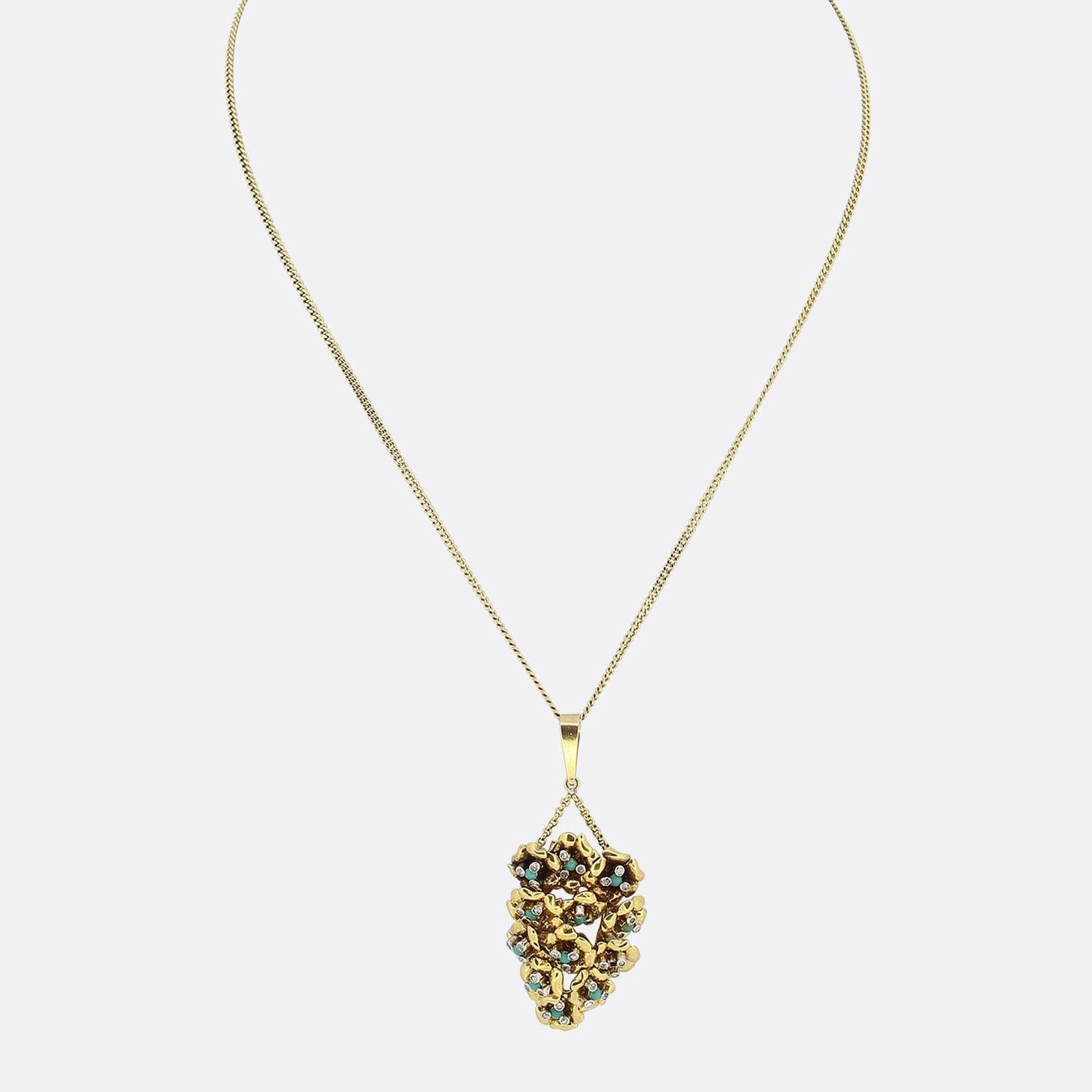 This is a vintage diamond and turquoise pendant. It has been set with multiple cabochon turquoise stones and thirty-six eight cut diamonds in a moveable setting that's been crafted in 18ct yellow gold. The bale is connected by a split chain and