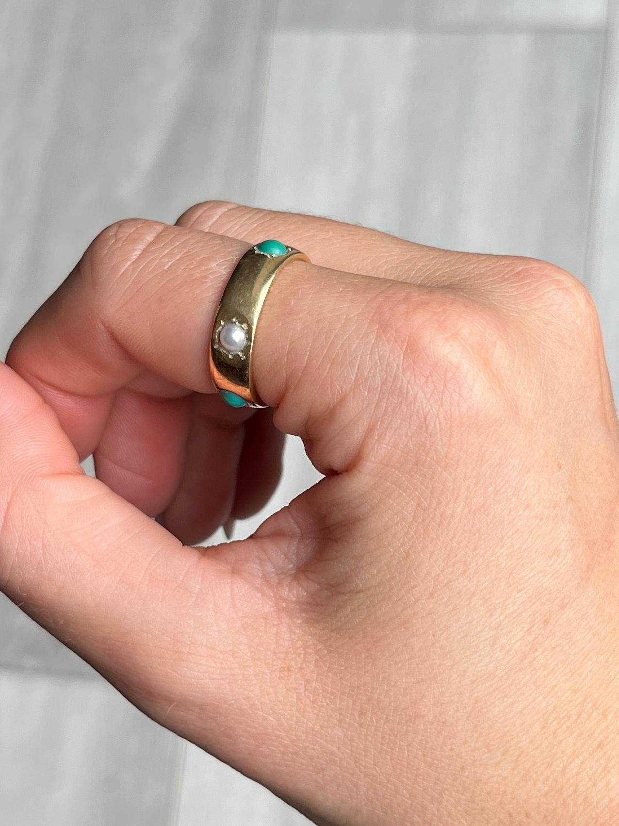 The turquoise and pearl pop next to the glossy 18ct gold and compliment each other beautifully. The chunky gold band holds three turquoise stones and three pearls. 

Ring Size: N 1/2 or 7
Band width: 6mm

Weight: 6.1g

