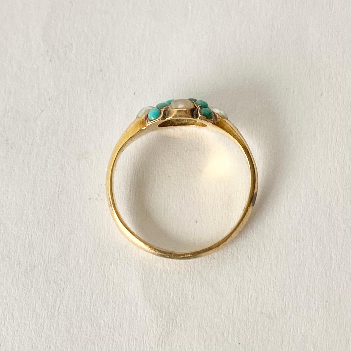The turquoise stones set within this ring almost make up a X 'kiss' shape and four pearls are set around them. The ring is modelled in 9ct gold.

Ring Size: J or 4 3/4 
Band Width: 8mm 

Weight: 2g 