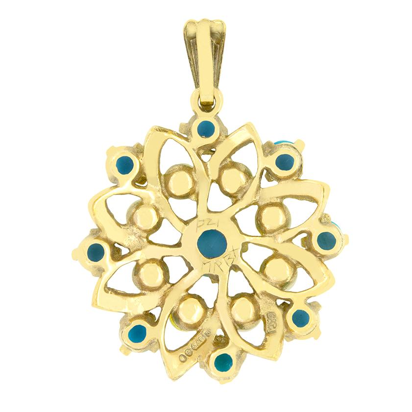 This charming Vintage pendant has been crafted in 9 carat gold. The pendant is adorned with pearls and turquoise in a concentric pattern, each set across the flower like metal design. This wonderful pendant is 3cm in height and 2.4cm in width and