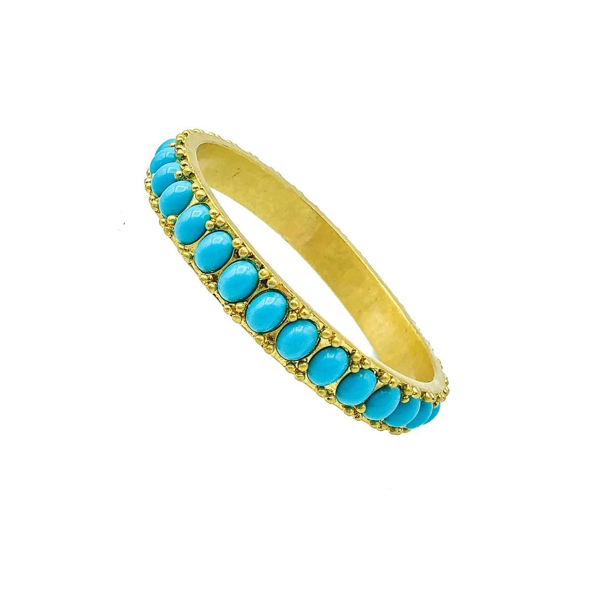 A striking vintage Turquoise Bangle. Crafted in very weighty gold tone metal set with resin cabochon oval turquoise stones. Very good vintage condition, 6.2cms internal diameter. A perfect piece of vibrant arm candy stacked or solo. 

Established in