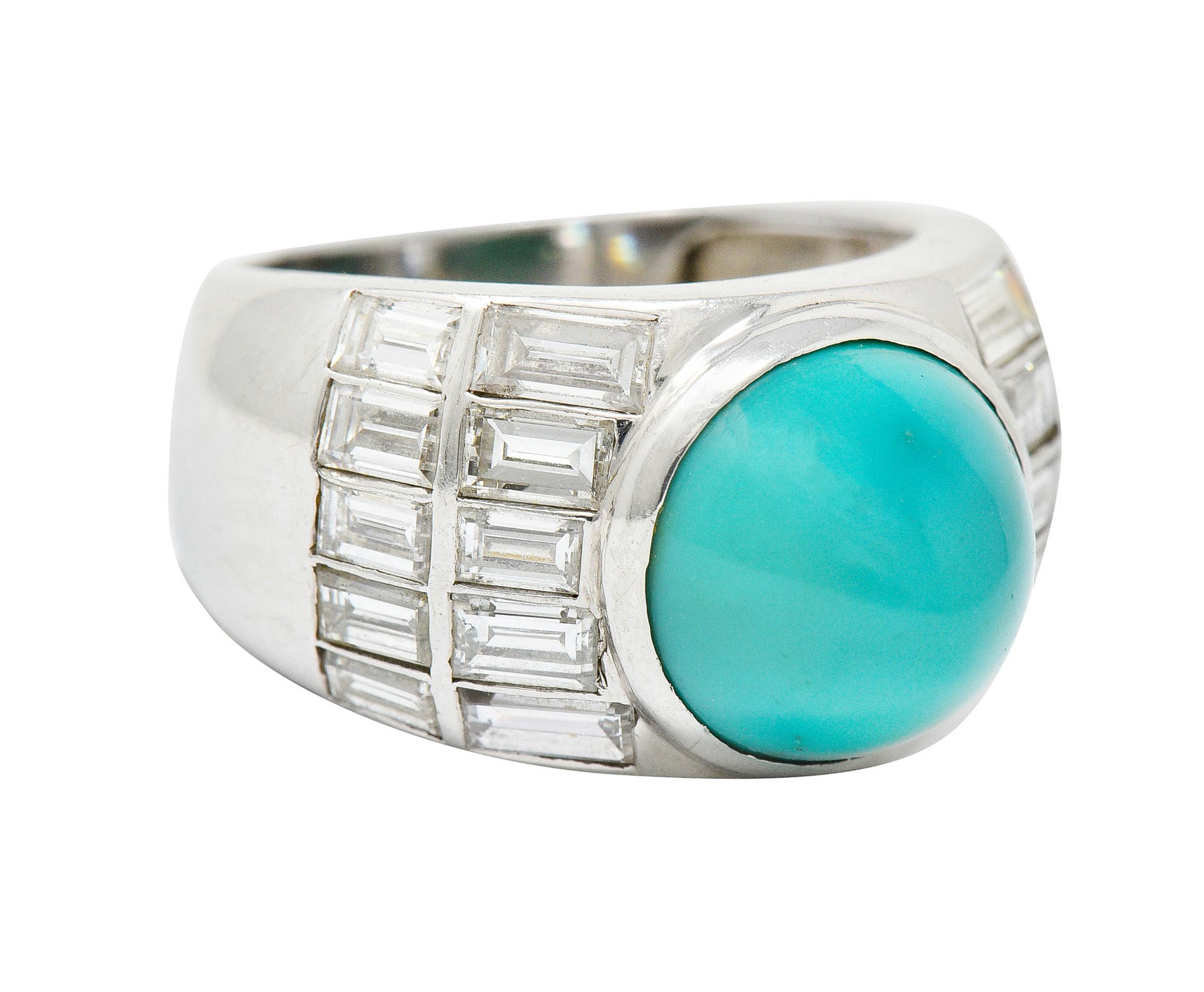 Wide band ring centers a 10.5 mm highly domed bullet cabochon of turquoise

Opaque with uniform green/blue color and very little matrix

Flanked by rows of bezel set baguette cut diamonds

Weighing in total approximately 2.50 carats with G to I