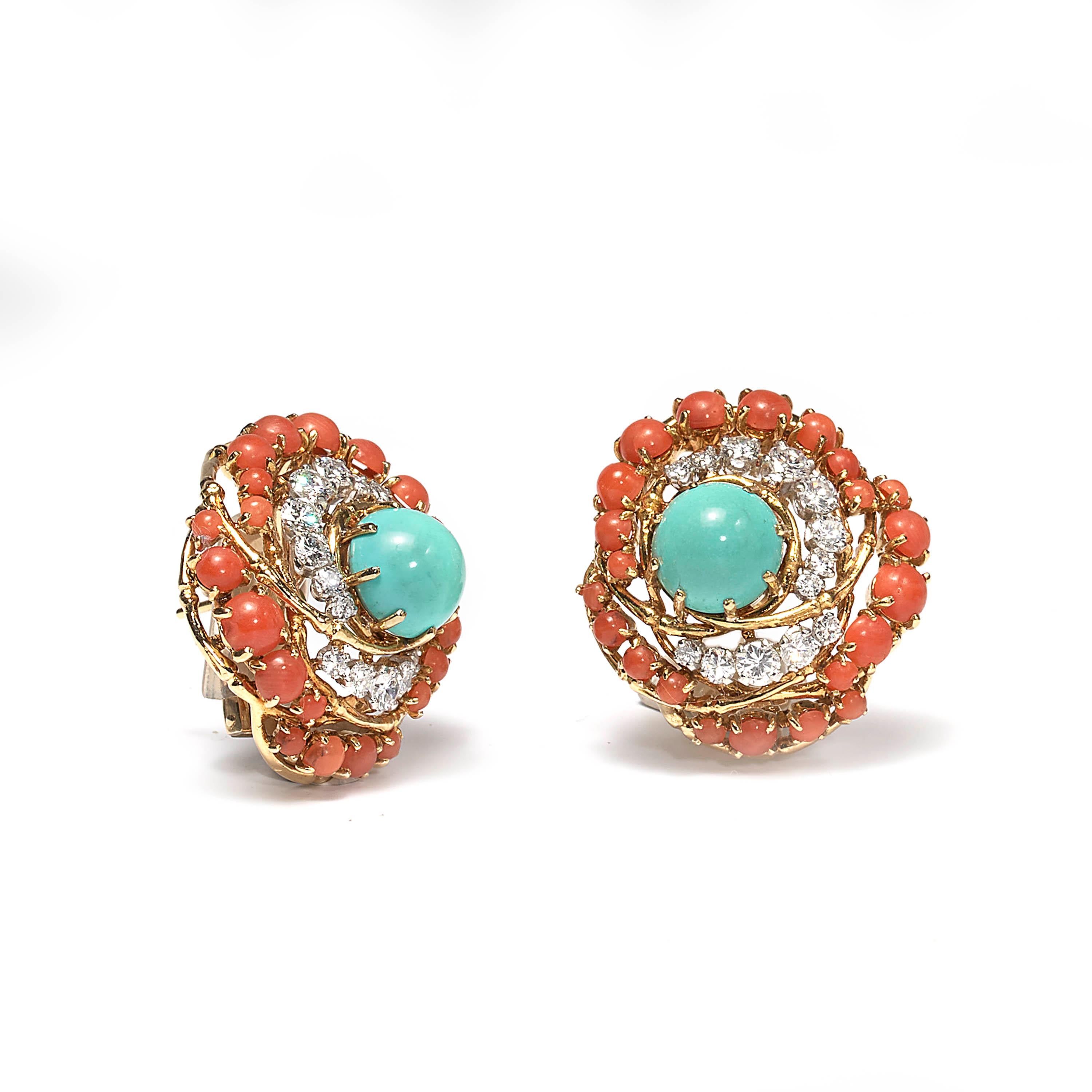 A pair of turquoise, coral and diamond cluster ear clips, cabochon cut turquoise, claw set at the centre of a swirl designed surround of round brilliant cut diamonds and round cabochon cut corals, mounted in 18ct yellow gold with French hallmarks.