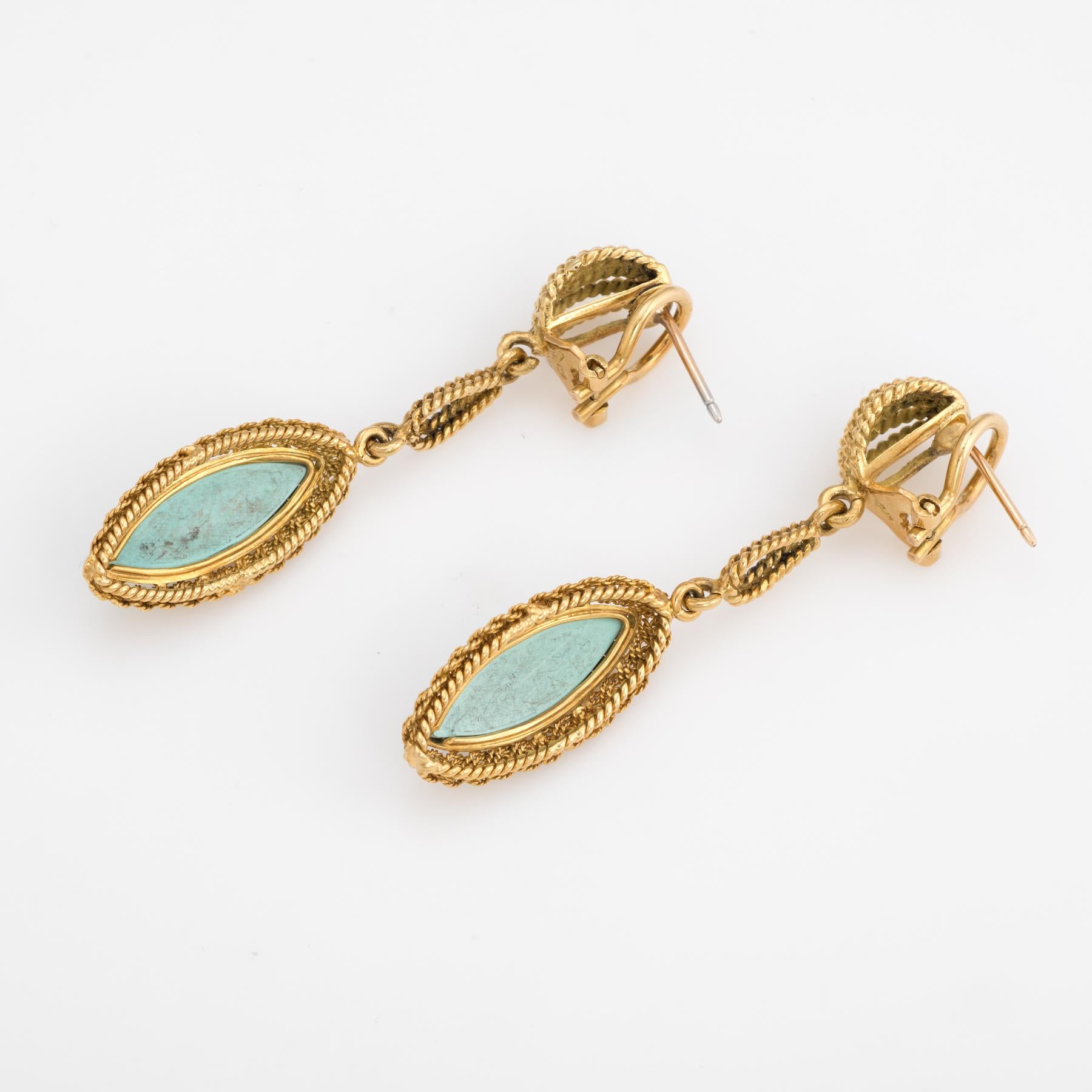 Elegant pair of vintage turquoise earrings (circa 1960s), crafted in 18k yellow gold. 

Cabochon cut turquoise measures 20mm x 7mm (estimated at 4 carats each - 8 carats total estimated weight). Note: slight chips and color variance to the