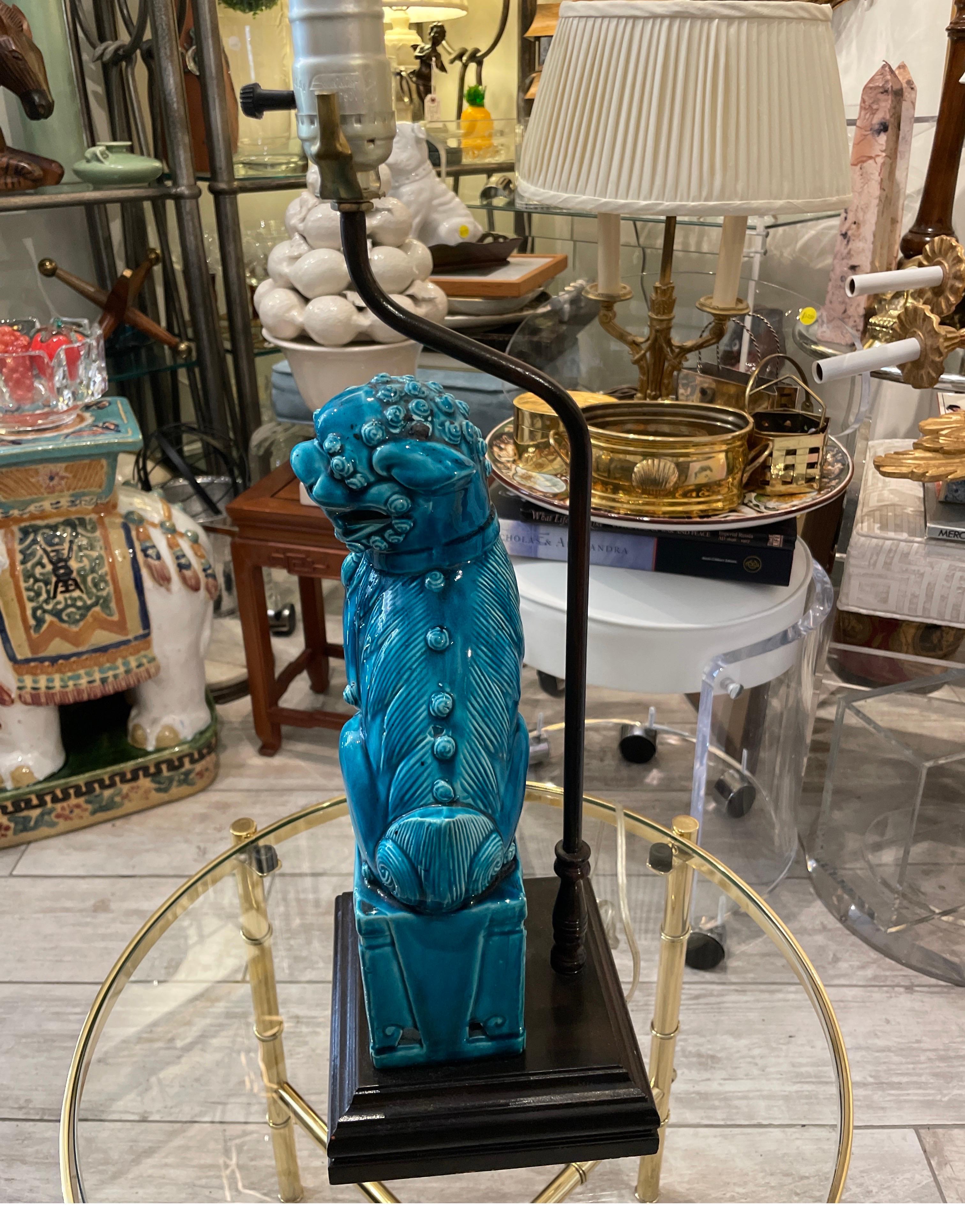 Vintage Turquoise Foo Dog lamp on black wood base.