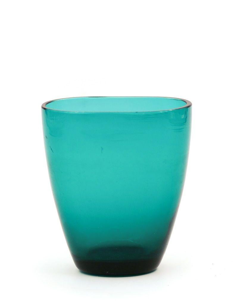 This vintage turquoise glass vase is a decorative glass object manufactured in Northern Europe in 1970s.

Small turquoise vase with the shape of an elongated goblet.

Dimensions: cm 10 x 8.5 x 6.

In excellent conditions.