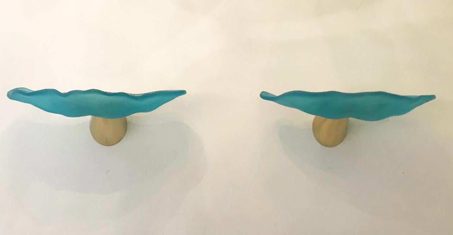 Turquoise hand blown glass wall lights
Designed by I Tre, Italy, 1980
Brass-plated cone shape mounting
Gives off warm beams of light
Wired to the American standard
Located in our store in Miami ready for shipping.
2 pairs available now
Priced