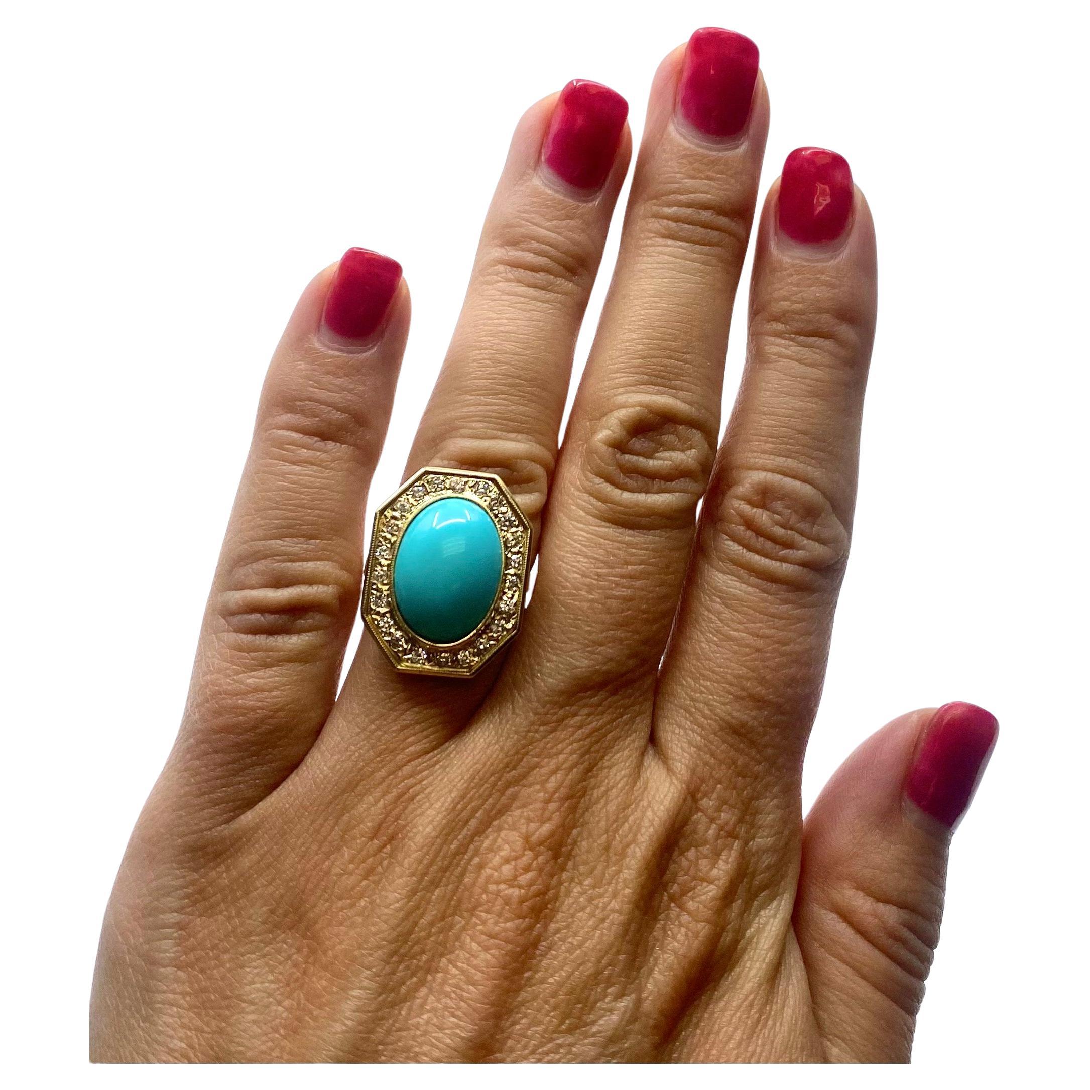 A gorgeous octagon shape turquoise ring, made of 14k gold, features diamonds. The turquoise of a great robin egg blue color is cabochon cut. The hammered gold octagon frame is adorned with diamonds. The gems dazzle being set in the textured gold