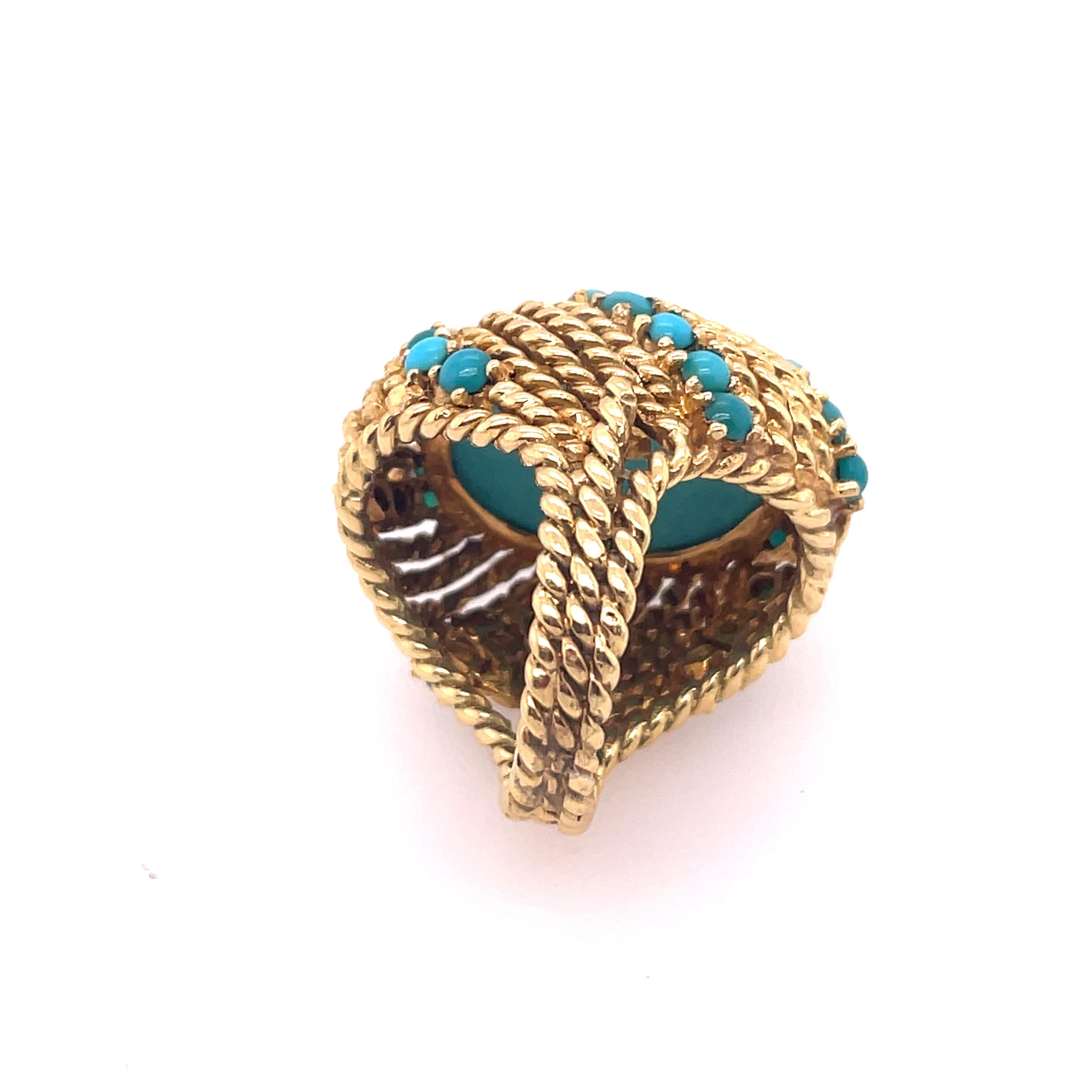 Vintage 18kt yellow gold ring with beautiful uniform medium slightly greenish turquoise blue stone with good luster. Braided gold accents and band.



1 1/8 x 7/8 inches.
