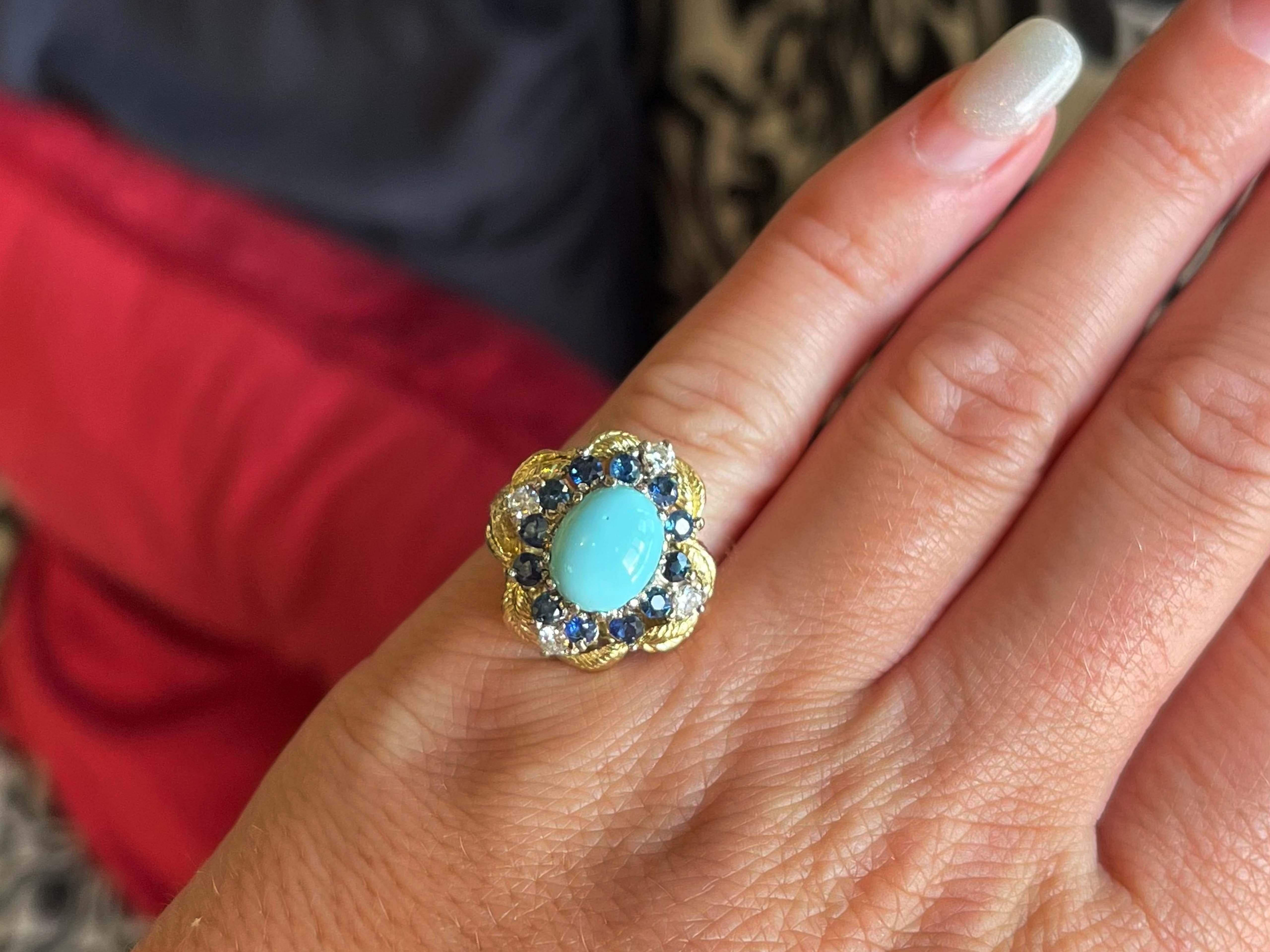 Specifications:

Metal: 18k Yellow Gold
​​​​Ring Size: 5

Center Gemstone: Blue Turquoise
​
​Turquoise Measurements: ~ 9.95 mm x 7.95 mm x 4.20 mm 
​
​Turquoise Carat Weight: ~2.5 carats
​
​Sapphire Count: 12 round sapphires
​
​Sapphire Carat