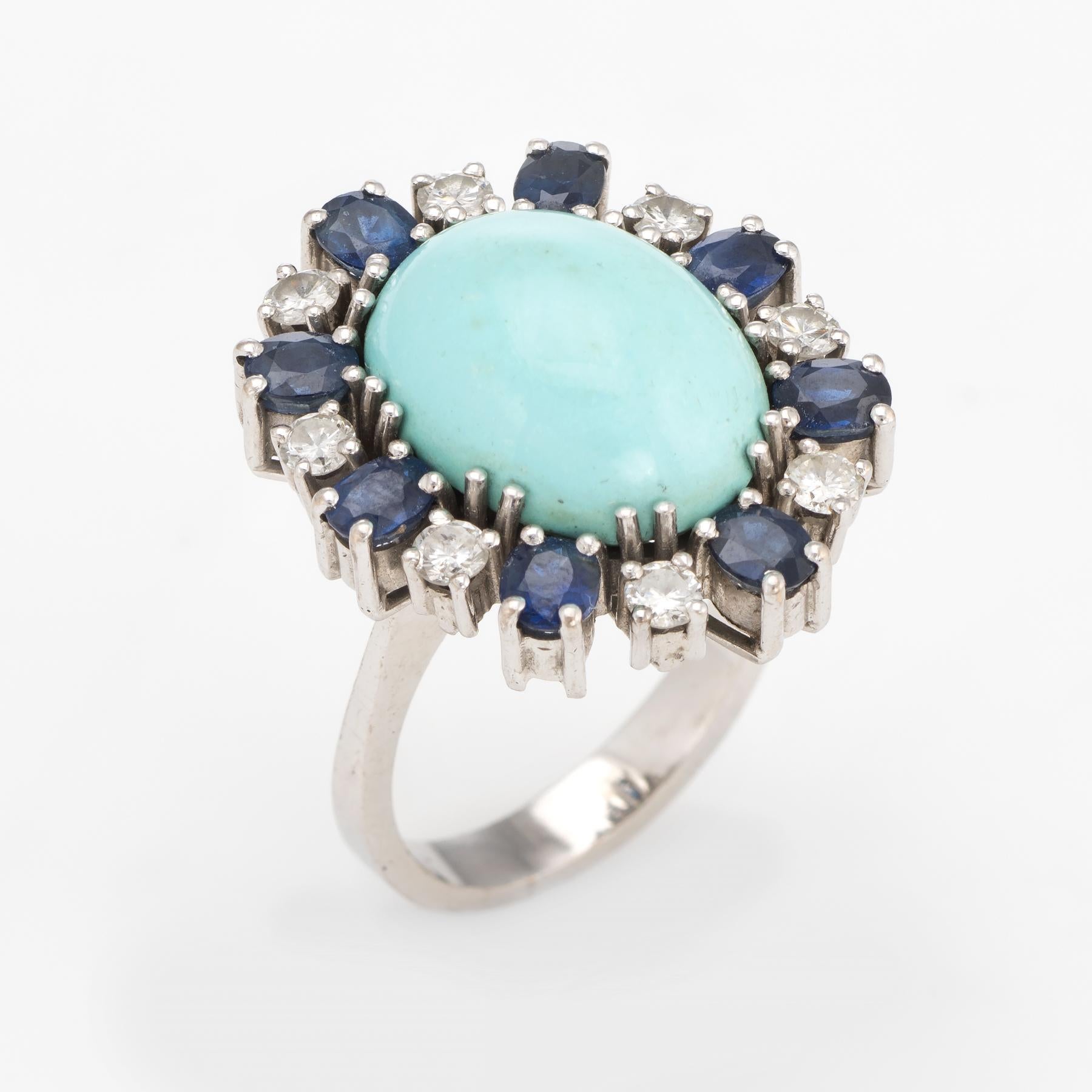Distinct & stylish egg shell blue turquoise, sapphire & diamond ring (circa 1950s to 1960s), crafted in 18 karat white gold. 

Cabochon cut Persian turquoise measures 16mm x 12mm (estimated at 7 carats), accented with 7 estimated 0.24 carat oval