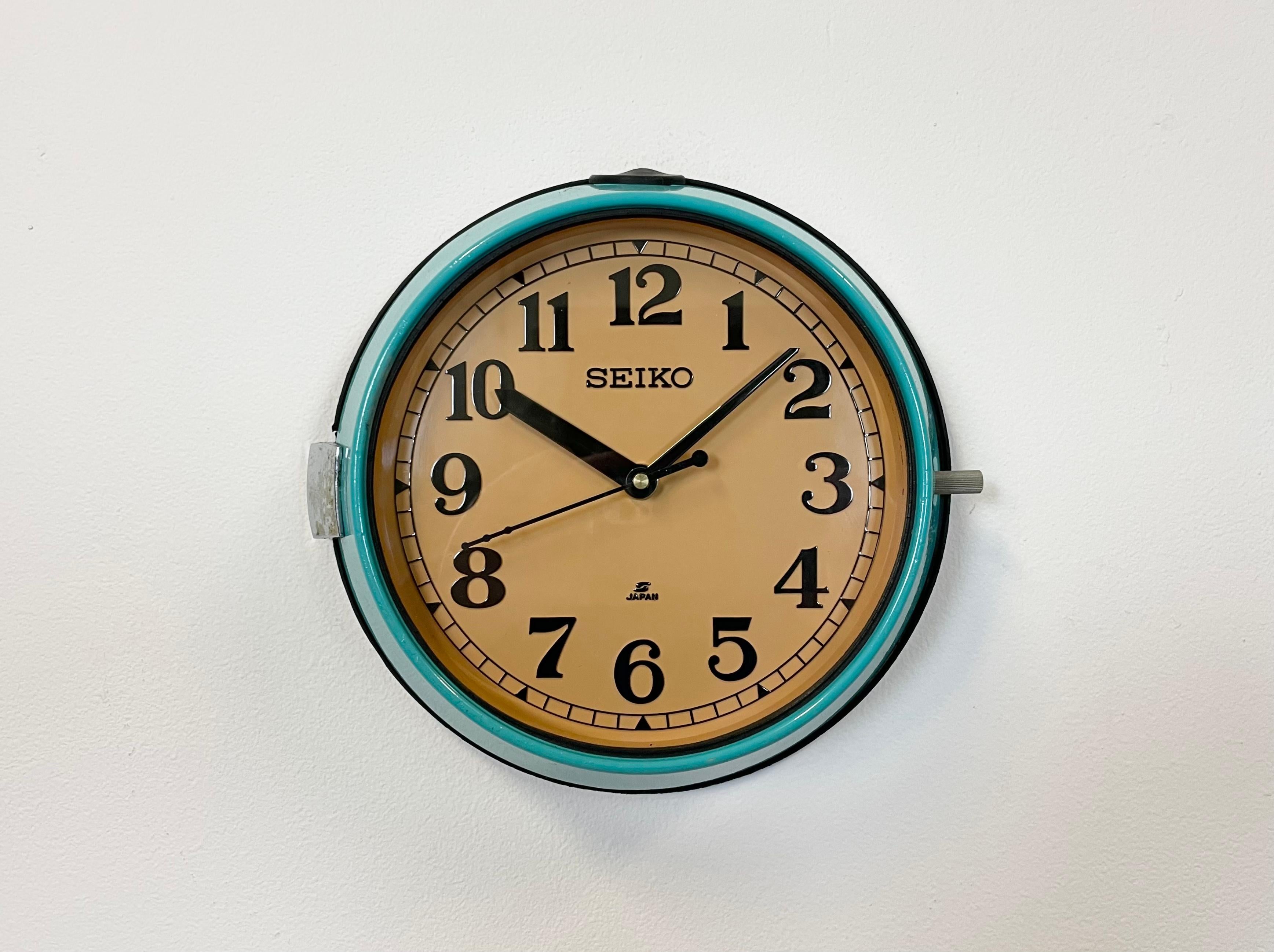 Vintage Seiko navy slave clock designed during the 1970s and produced till 1990s. These clocks were used on large Japanese tankers and cargo ships. It features a turquoise metal frame, a plastic dial and clear glass cover. This item has been