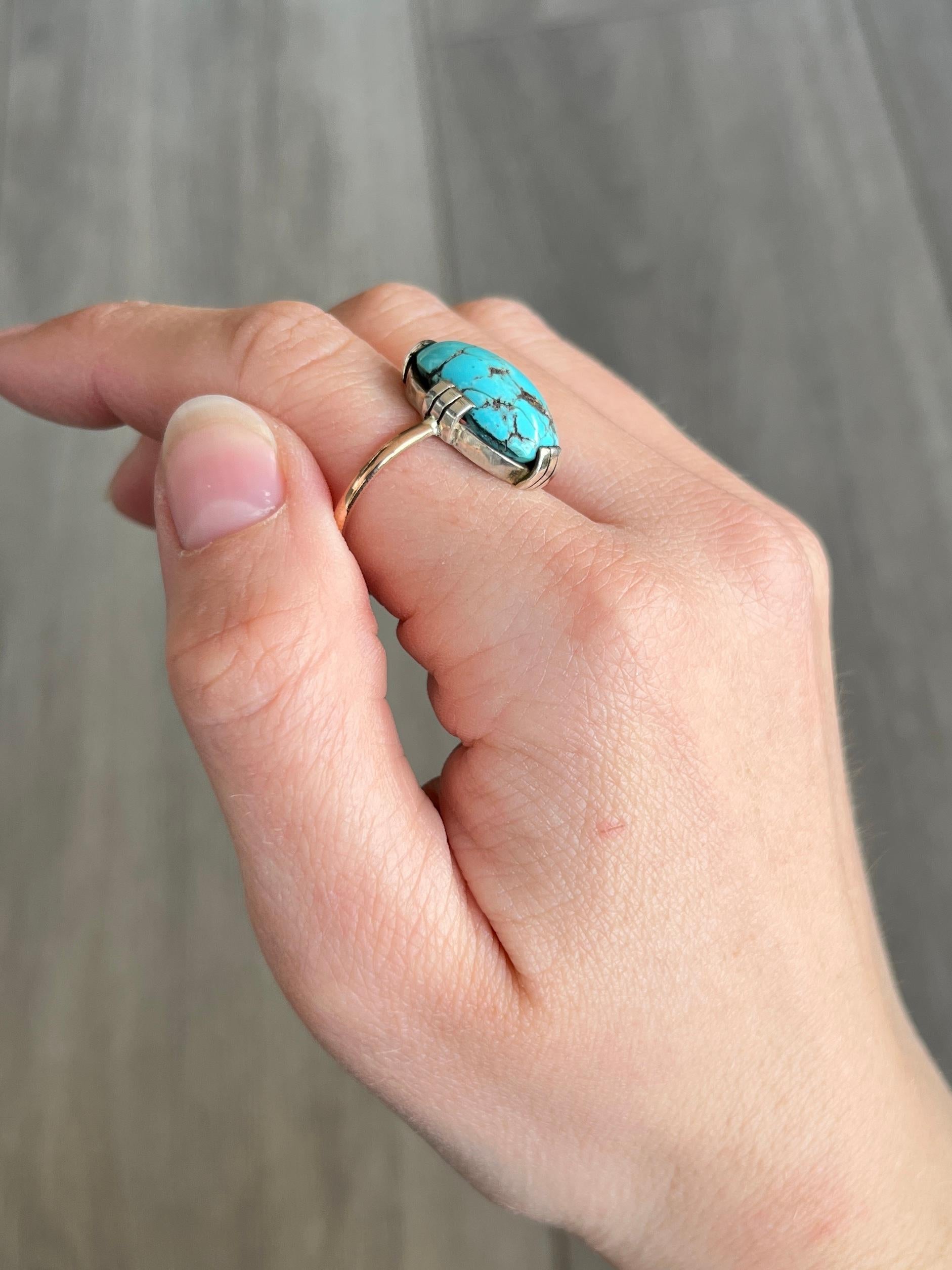 This beauty has a large turquoise stone that pops next to the silver and the rose gold band. Modelled in silver and 15carat rose gold. 

Ring Size: U 1/2 or 10 1/4 
Stone Dimensions: 18x12mm

Weight: 4.4g