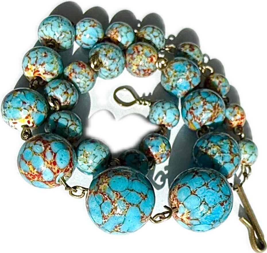 Superb Vintage turquoise stone composite beaded necklace. The necklace features round beads with a light blue base and brown, red, and yellow veining patterns. The beads are connected by gold-toned metal links, and the necklace has a hook and eye