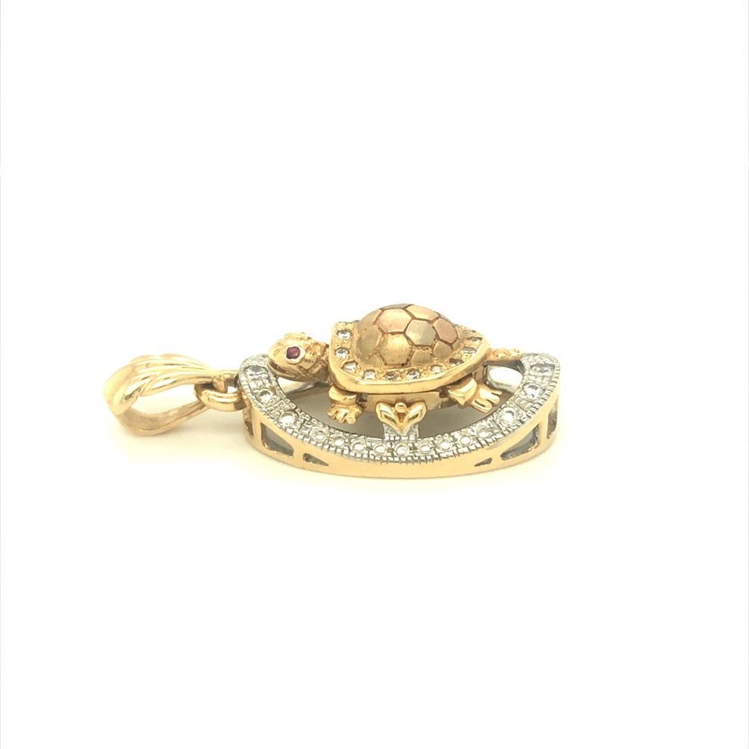 This whimsical turtle pendant is finely crafted in 14K Tri color gold. Total diamond weight on this pendant is approximately 0.60 carat with G-H, SI quality. It measures 0.69 W x 1 L x .375 H in inches. With the hoop, it is about 1.5 inch long. 