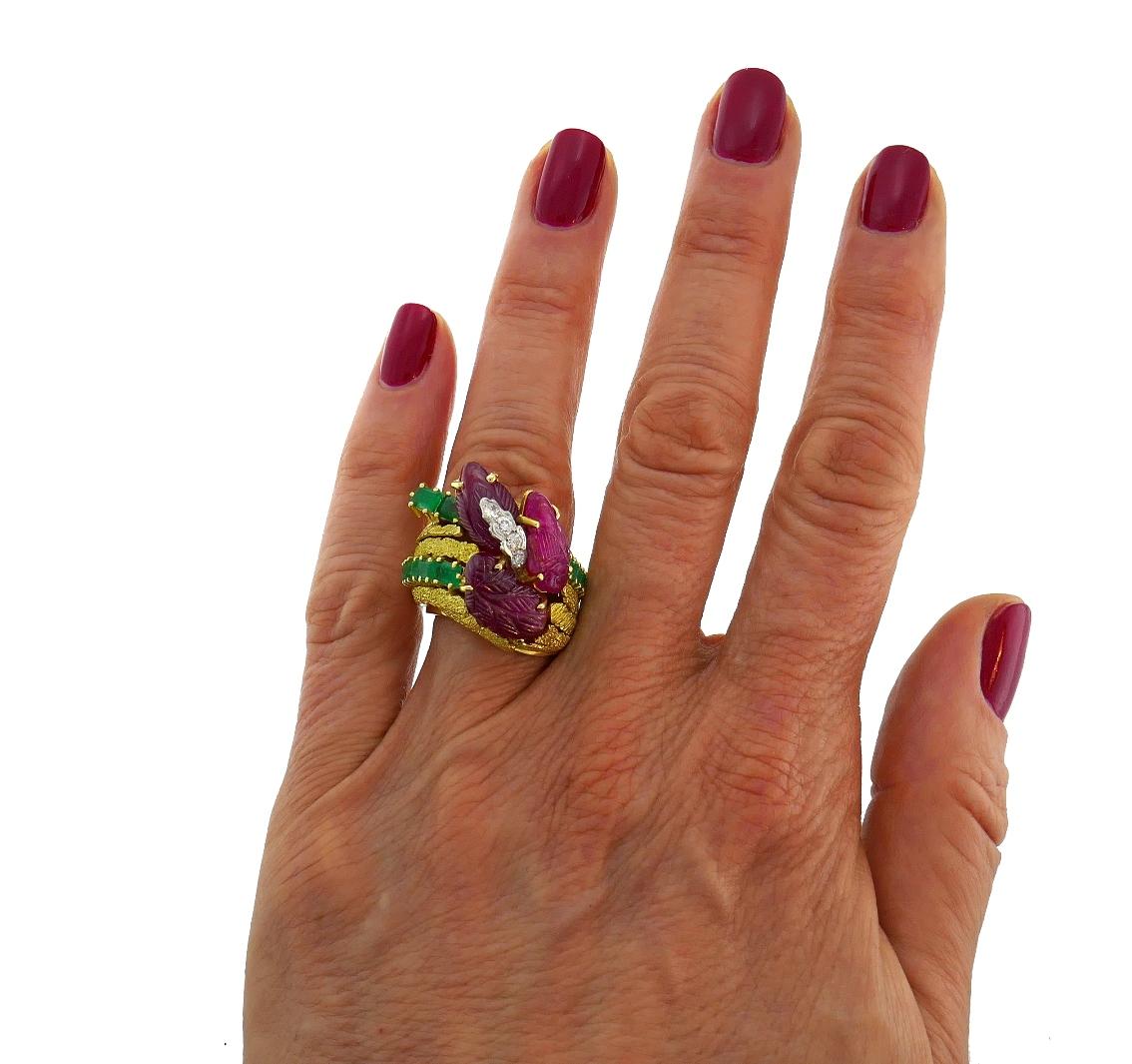 Colorful tutti-frutti motifs ring featuring four carved rubies set in 18 karat (tested) yellow gold and accented with transitional Old European cut diamonds (G-H color, VS clarity, 0.20 carat approximate total weight) and step cut emeralds (0.75