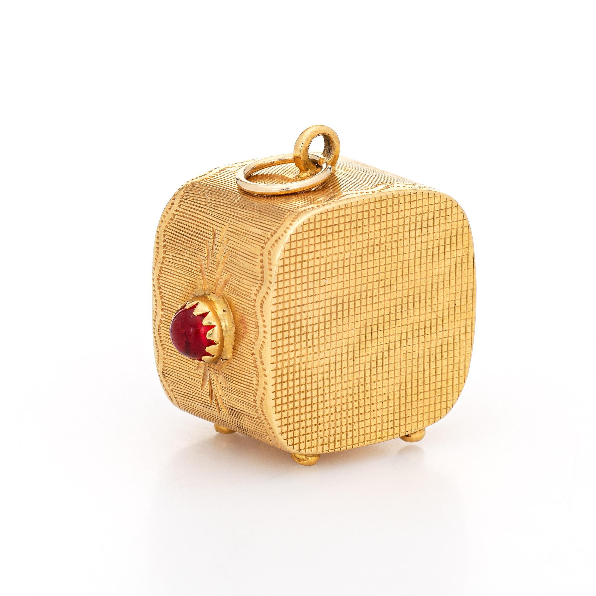 Finely detailed vintage TV set charm crafted in 18k yellow gold (circa 1960s).  

Red Stones measure 14mm x 12mm (center) and 4mm (sides). The stones are in excellent condition and free of cracks or chips. 

The unique charm is crafted in the form