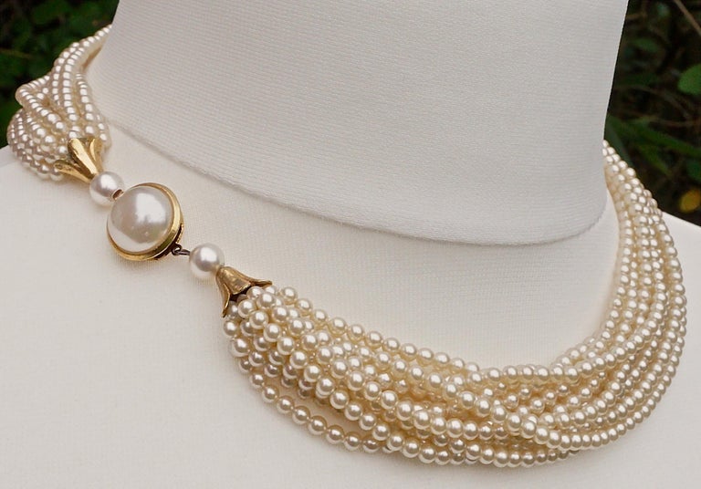 Twelve Strand Glass Pearl Necklace with a Gold Tone and Pearl Clasp at
