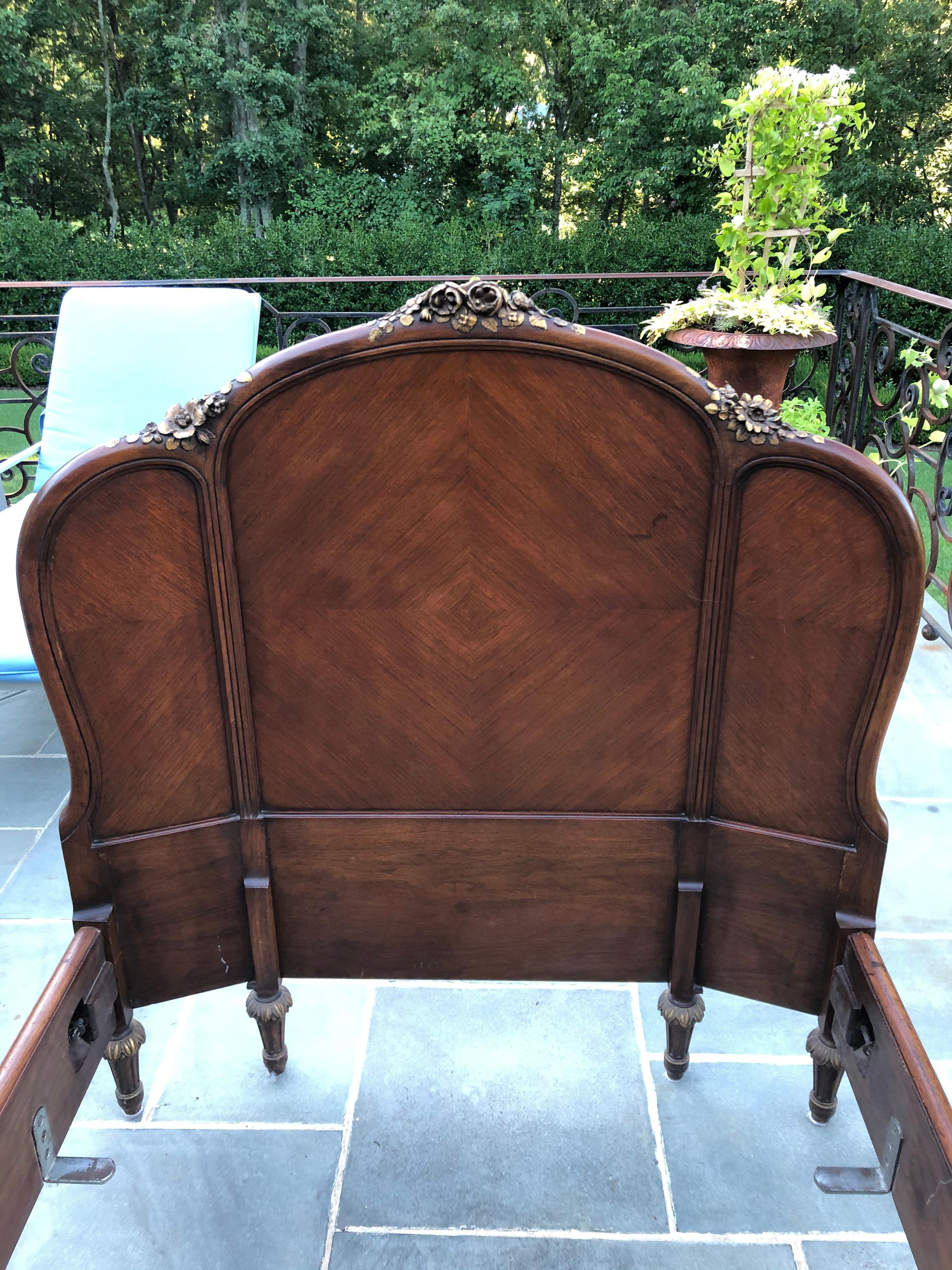 This elegant twin-size bed features beautifully carved gold-leaf roses on the crest and angled headboard. The foot-board has a inlay at the center and two carved posts with gold leaf. Two side-rails complete the bed frame. 1100A standard twin size