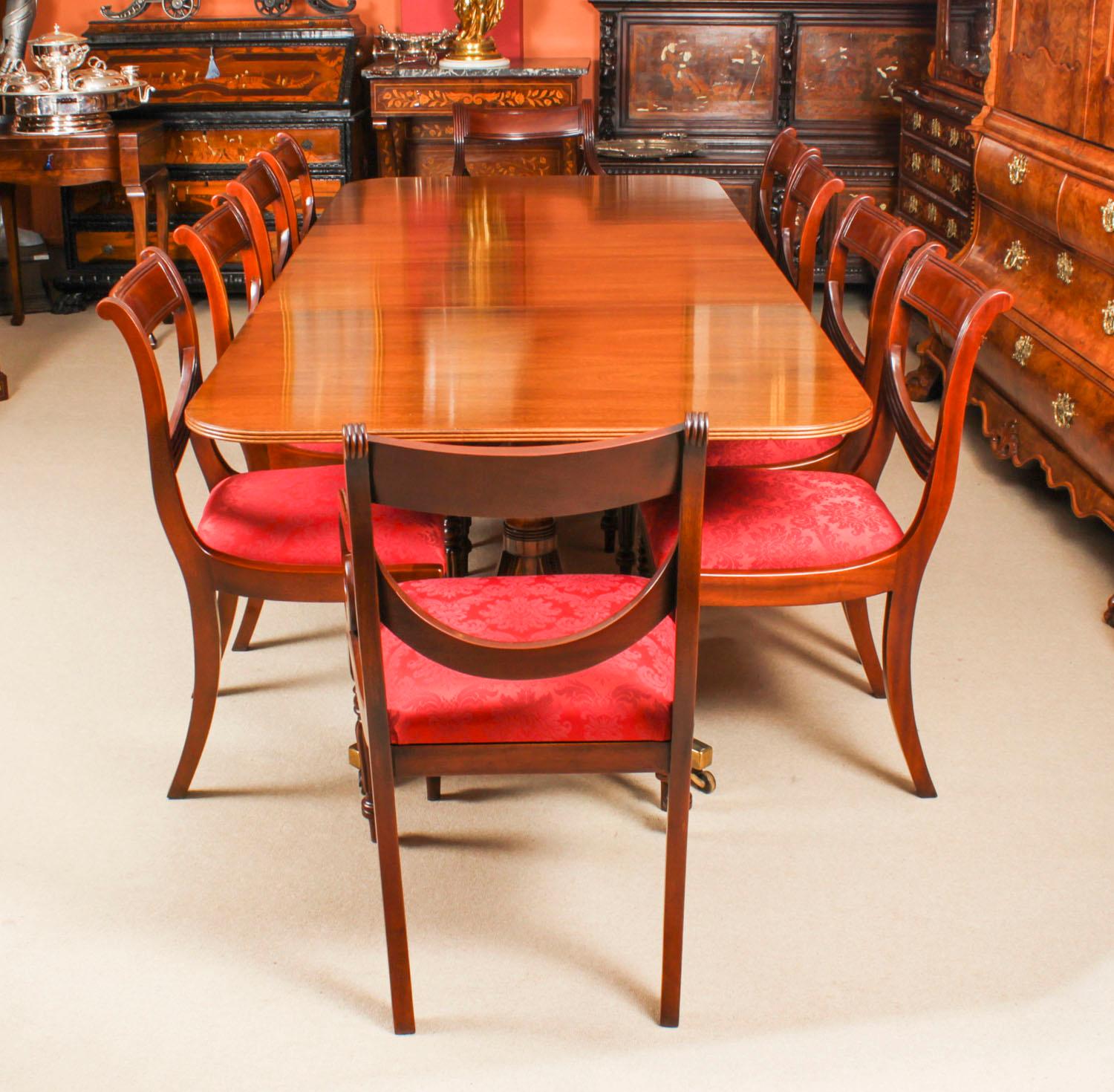 This is a fabulous Vintage Regency Revival dining set comprising a dining table and a set of ten swag back dining chairs, by William Tillman, Circa 1975 in date.

The table is made of stunning solid flame mahogany and is raised on twin 