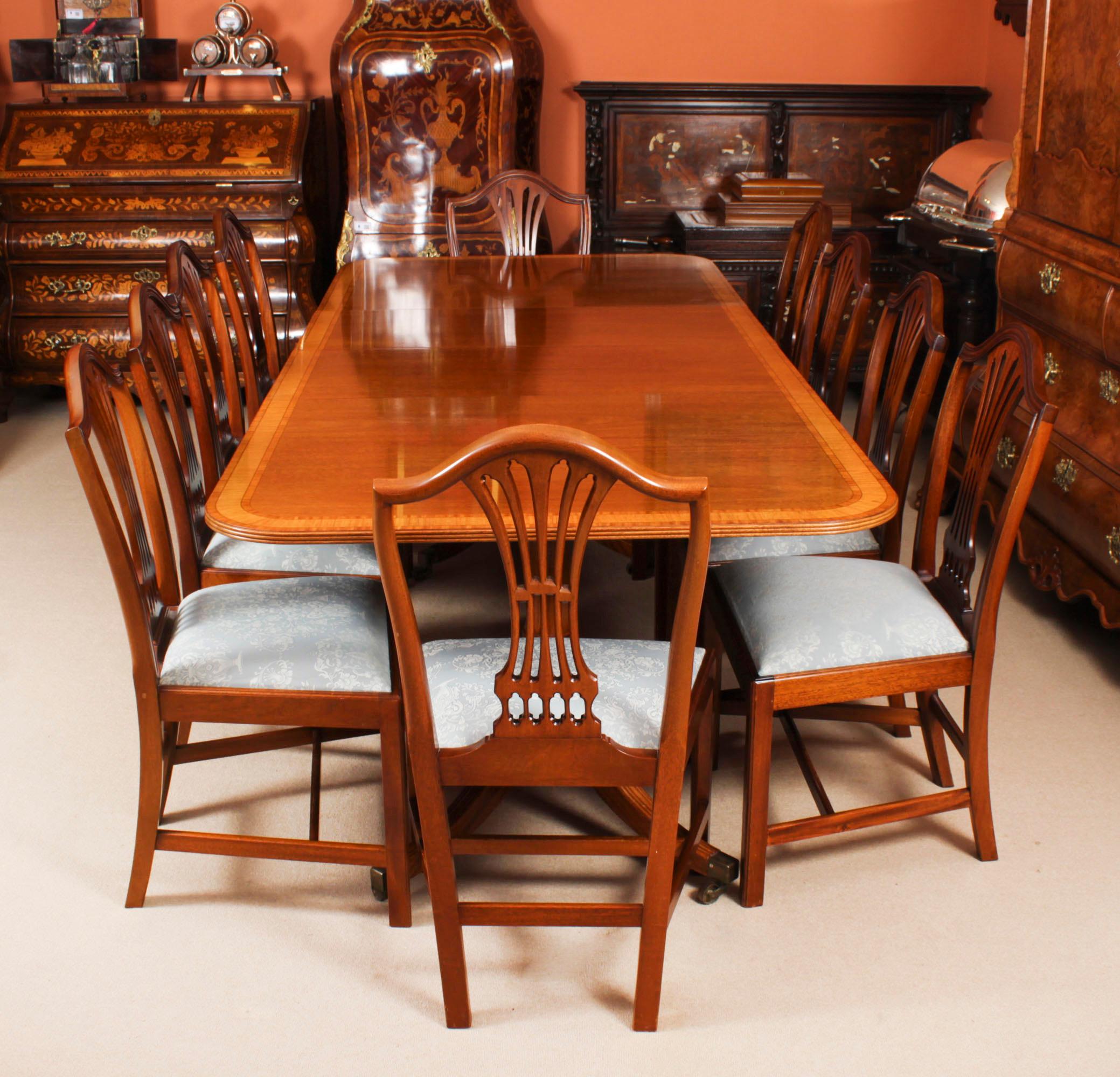 This is  fabulous Vintage Regency Revival  dining set  by the master cabinet maker William Tillman comprising a twin pillar crossbanded dining table with a set of ten Shield back dining chairs, Circa 1980 in date.

The table is made of stunning