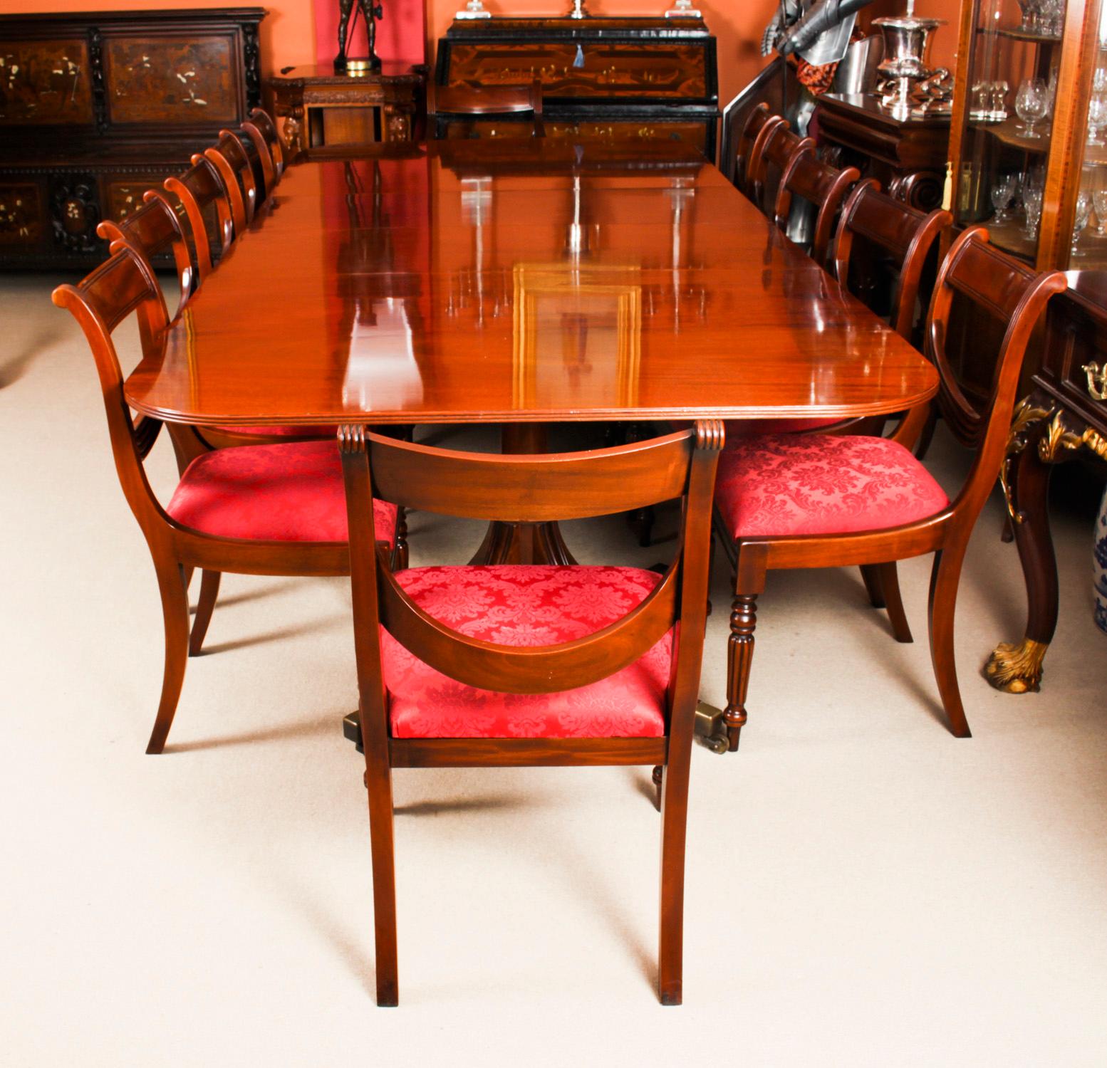 This is fabulous Vintage dining set comprising a Regency Revival dining table by William Tillman and a set of twelve Regency Revival Swag back dining chairs, Circa 1980 in date

The table is made of stunning solid flame mahogany and is raised on
