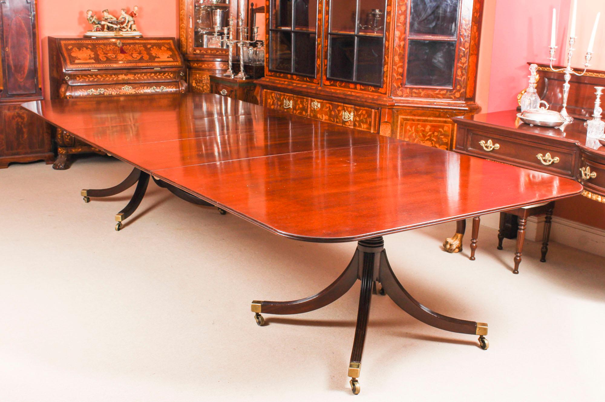 This is an elegant dining set comprising a vintage George III Regency style dining table, mid-20th century in date, with a fabulous set of fourteen antique Victorian dining chairs circa 1870 in date.

The table has two additional leaves which can